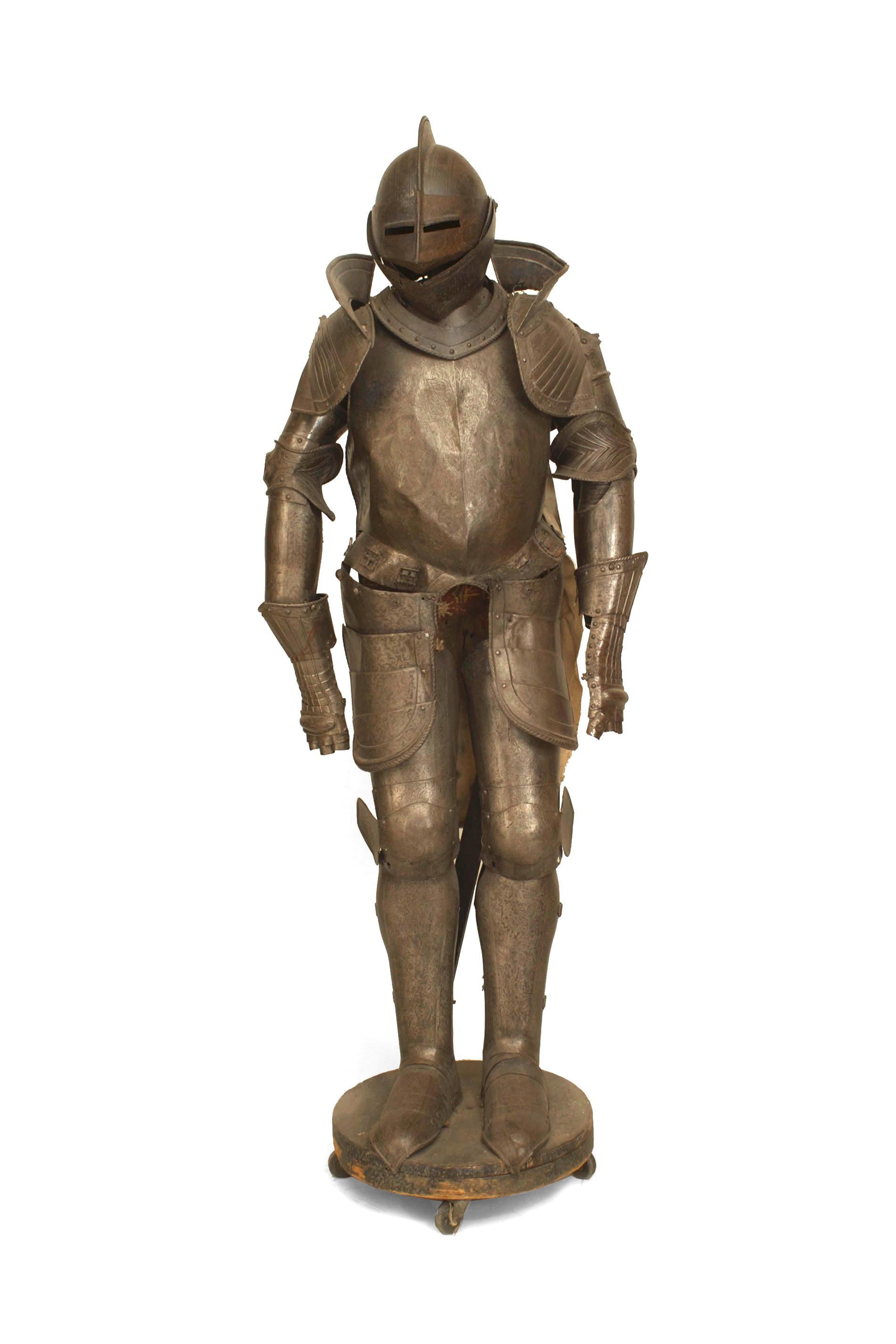 Italian Medieval / Renaissance-style (19th Century) small metal suit of armor with two Roman figures on the breast plate and an antique rolling stand.
