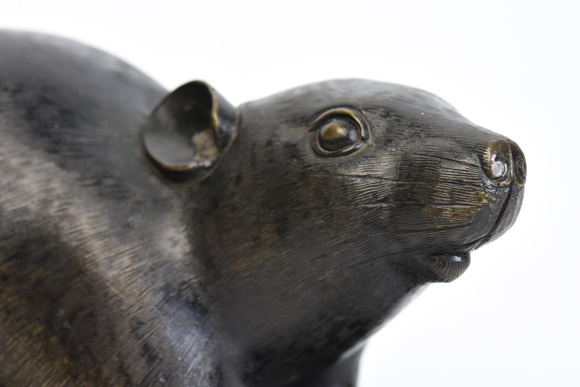 Japanese bronze animal rat / mouse holding a chestnut with artist sign.
Artist signature is on the last photo.

Age: Japan, Meiji Period, 19th Century
Size: Length 18 C.M. / Width 8.5 C.M. / Height 9 C.M.
Condition: Nice condition