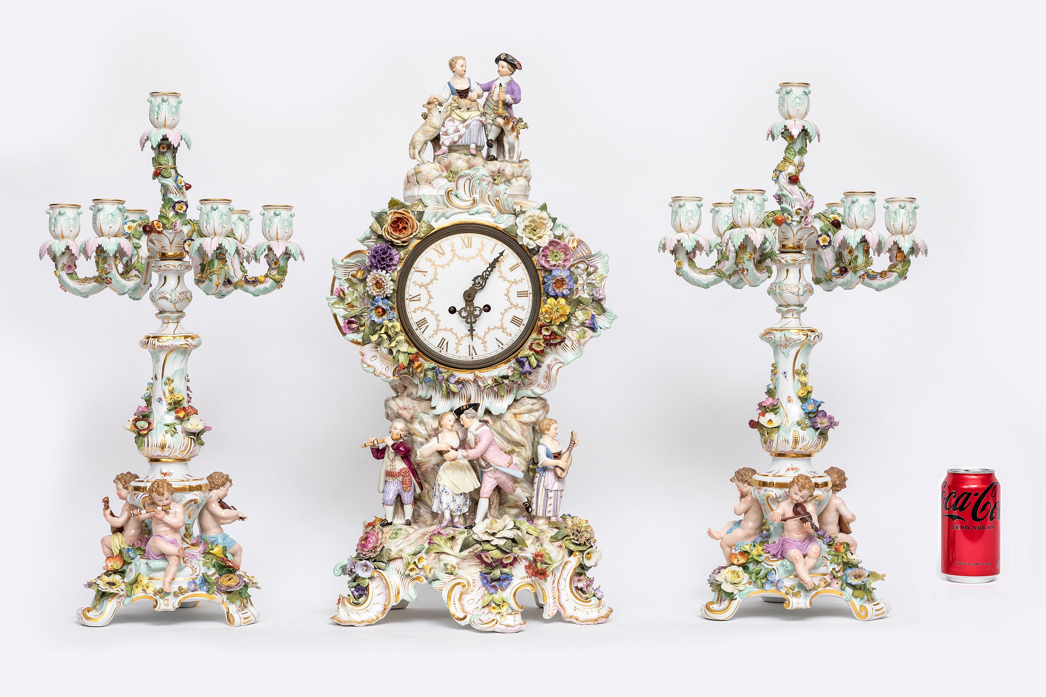 An impressive and rare 19th century Meissen Porcelain Musicians clock and Candelabra Garniture set. Comprised of three individual pieces, which include a gorgeous clock and two matching candelabras. The clock is impressive, with applied rococo