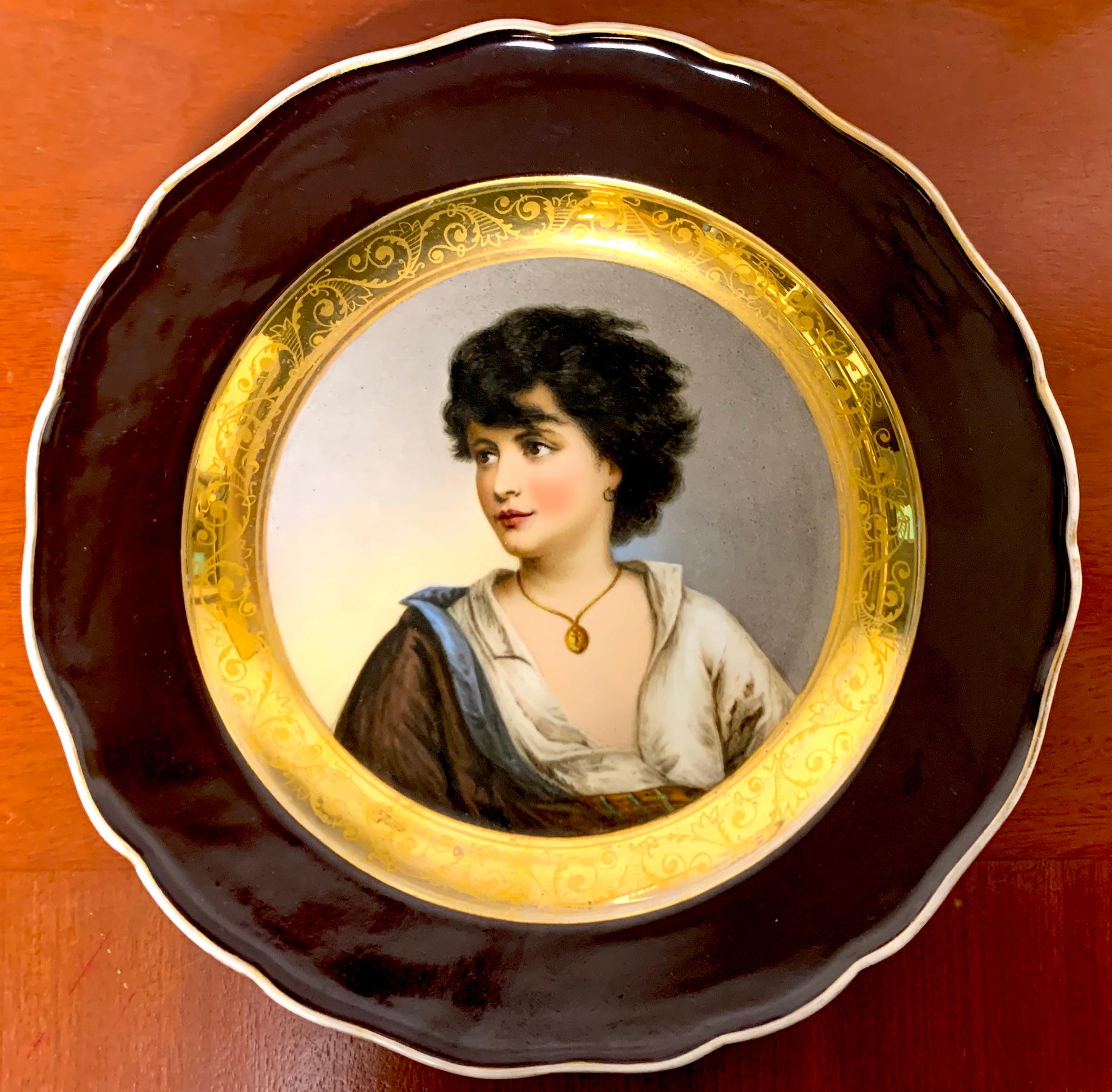 19th Century Meissen Portrait Plate of Young Girl With Necklace, With wide painted/ enamelled bronze edge with, gilt decorated surround, the well painted center portrait of a neoclassical beauty. Marked with blue underglaze crossed swords and