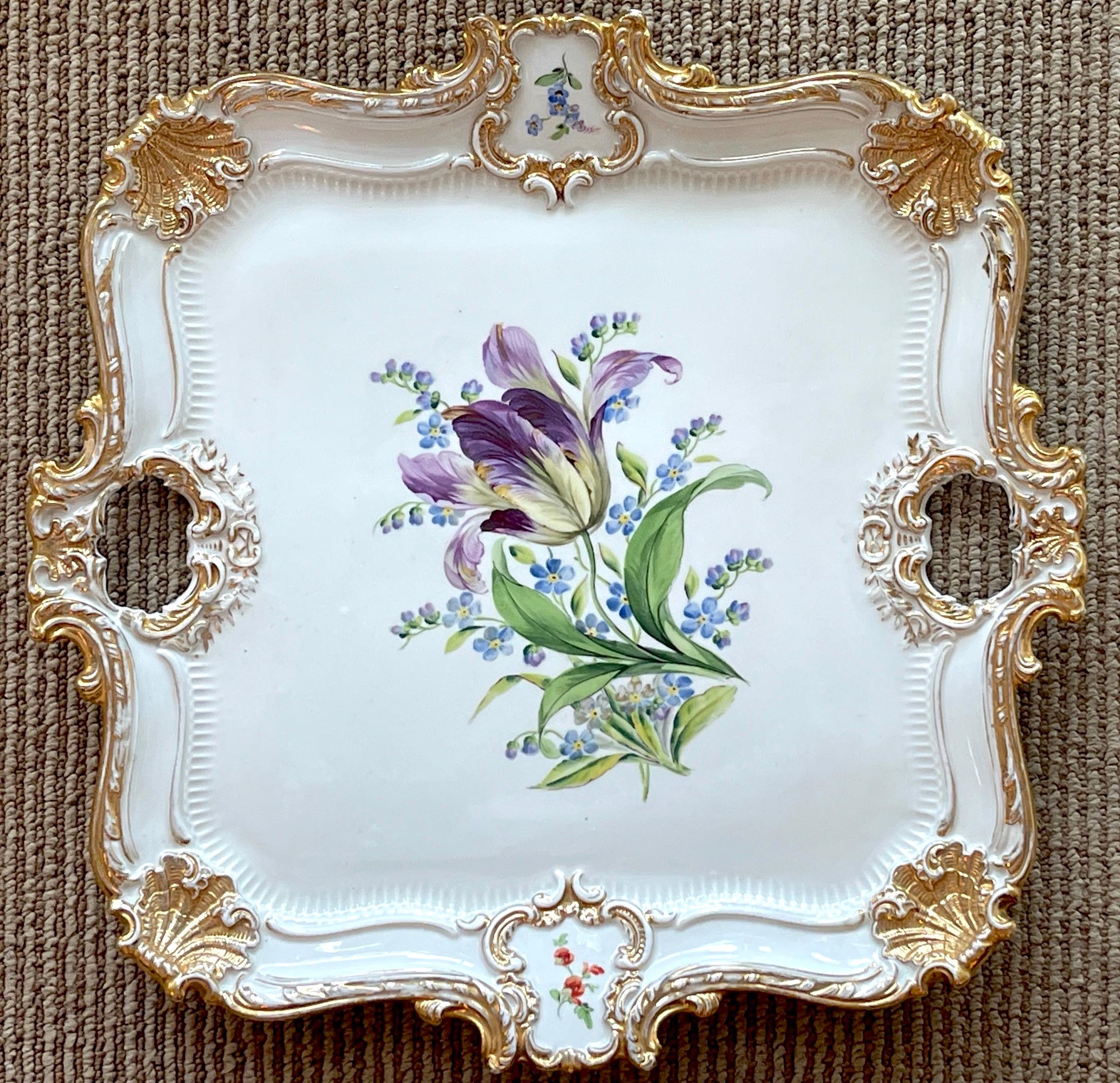 19th C Meissen Tulip Botanical Gilt Tray, Of square form, magnificently decorated with central floral vignette featuring a purple tulip, with gilt highlights with shell corners, and twin handles. Marked with blue crossed swords underglaze with two