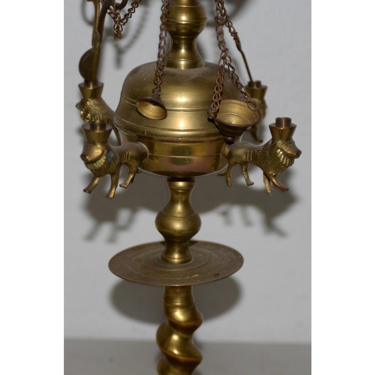 19th century Middle East brass oil lamp

Fine old oil lamp with swans and lions. The piece appears to be in very nice condition, though a piece or two may be Mission. We are unsure how this is suppose to work, but it's a nice decorative