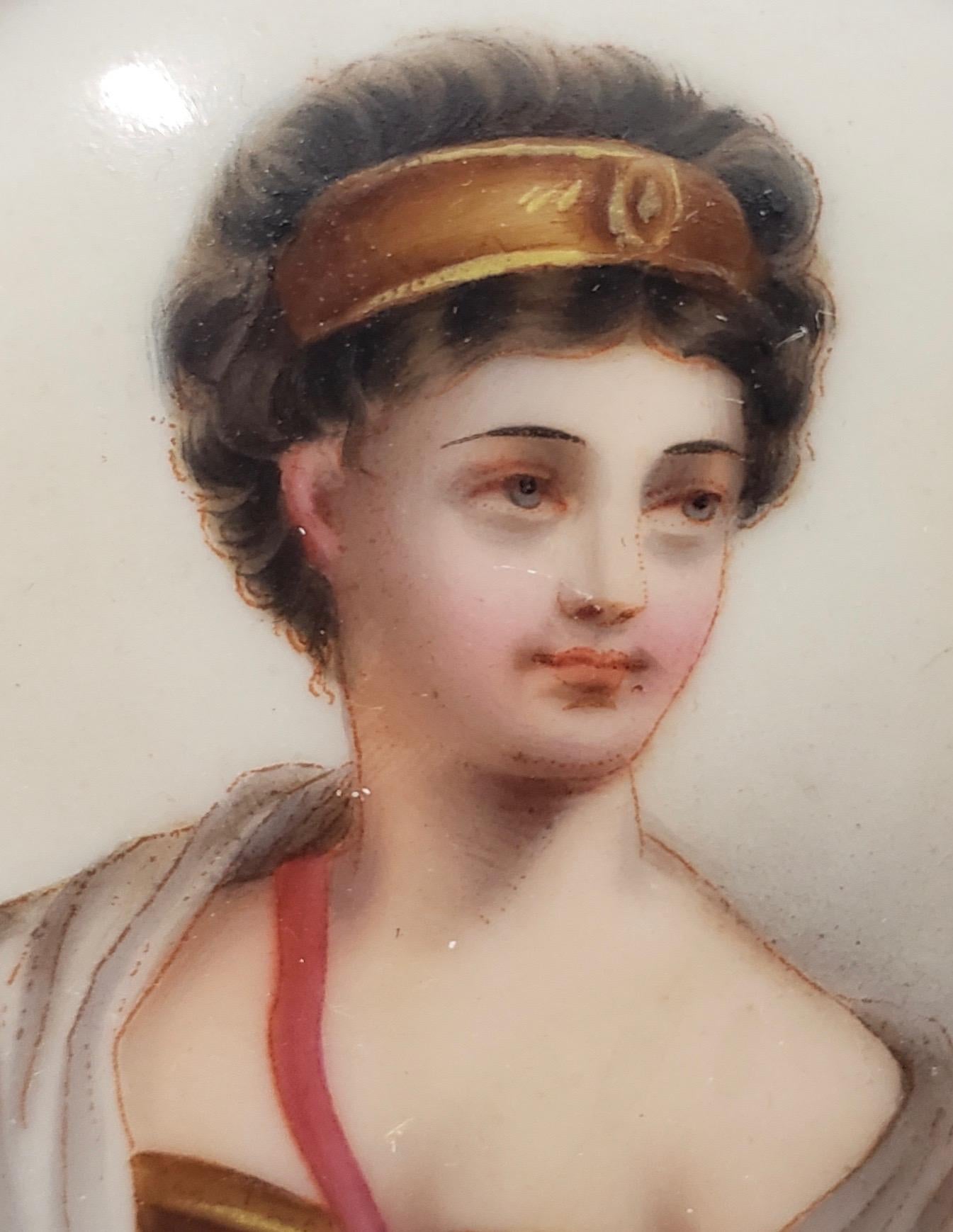 Fine 19th century miniature portrait on porcelain of a beautiful young woman

A finely detailed portrait of a young woman with short auburn hair and a gold head band.

The porcelain portrait is housed in a gilded brass frame with enamel paint