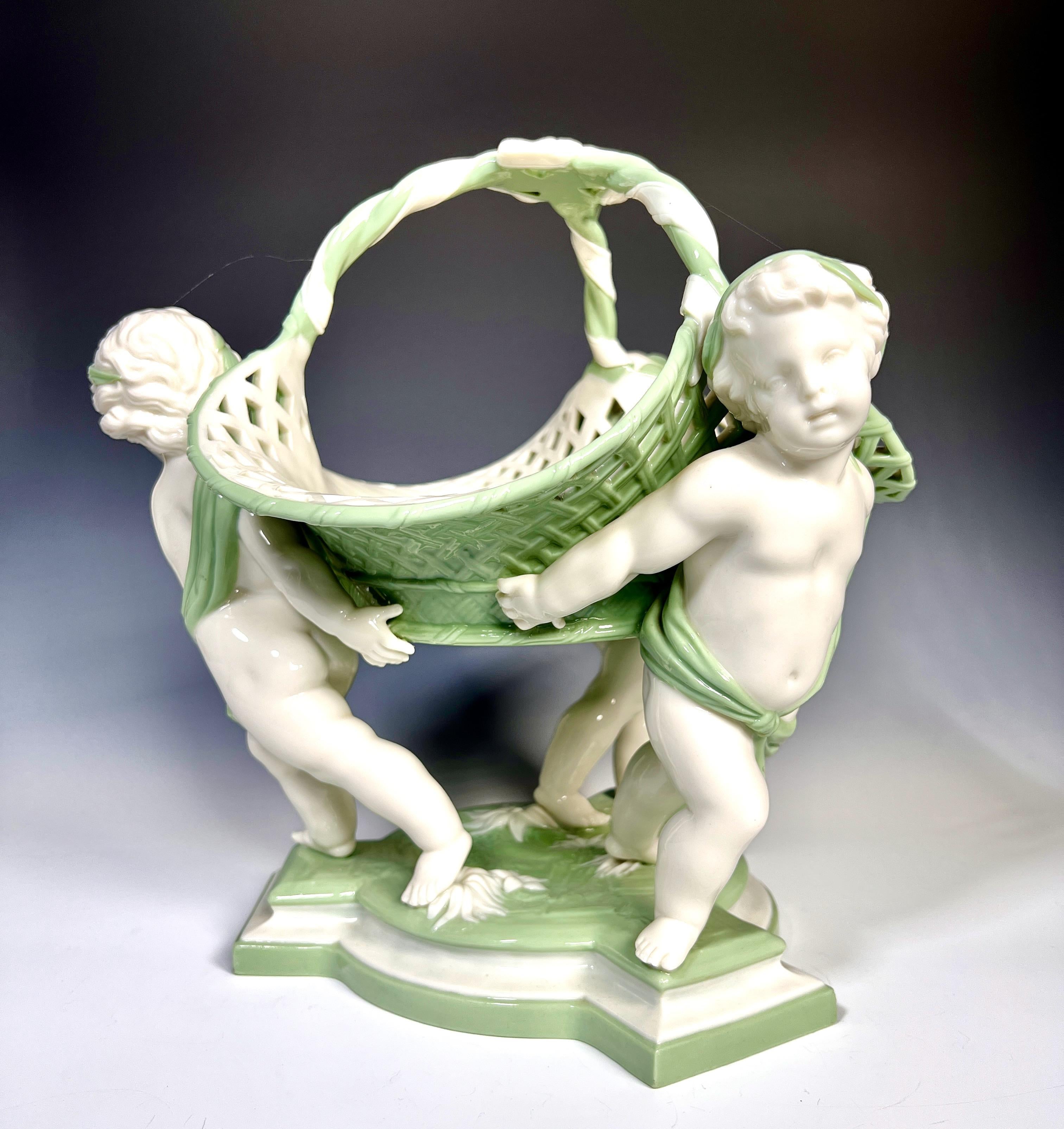A dramatic and large Minton Centerpiece in the form of a pierced basket upheld by three full sized 