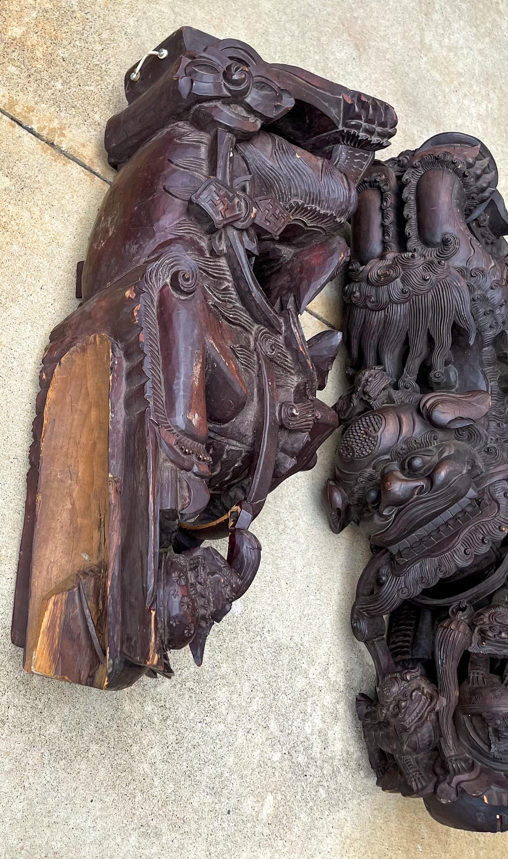 Wow! This is a pair or set of monumental Chinese corbels with heavily carved hanging food dogs and pups. The detail is incredible. The slightly smaller corbel is about 2 inches shorter. They are possibly rosewood. They date to the 19th century or