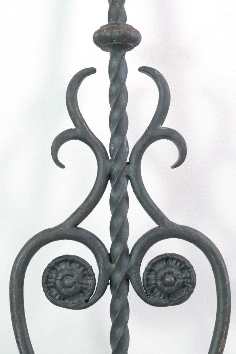 Ornate wrought iron balustrade originally part of a 19th century stair railing.  This antique ornament has a unique floral and twisted cast design.  It has a natural patina adding to its beauty.  This can be seen at our 400 Gilligan St location in