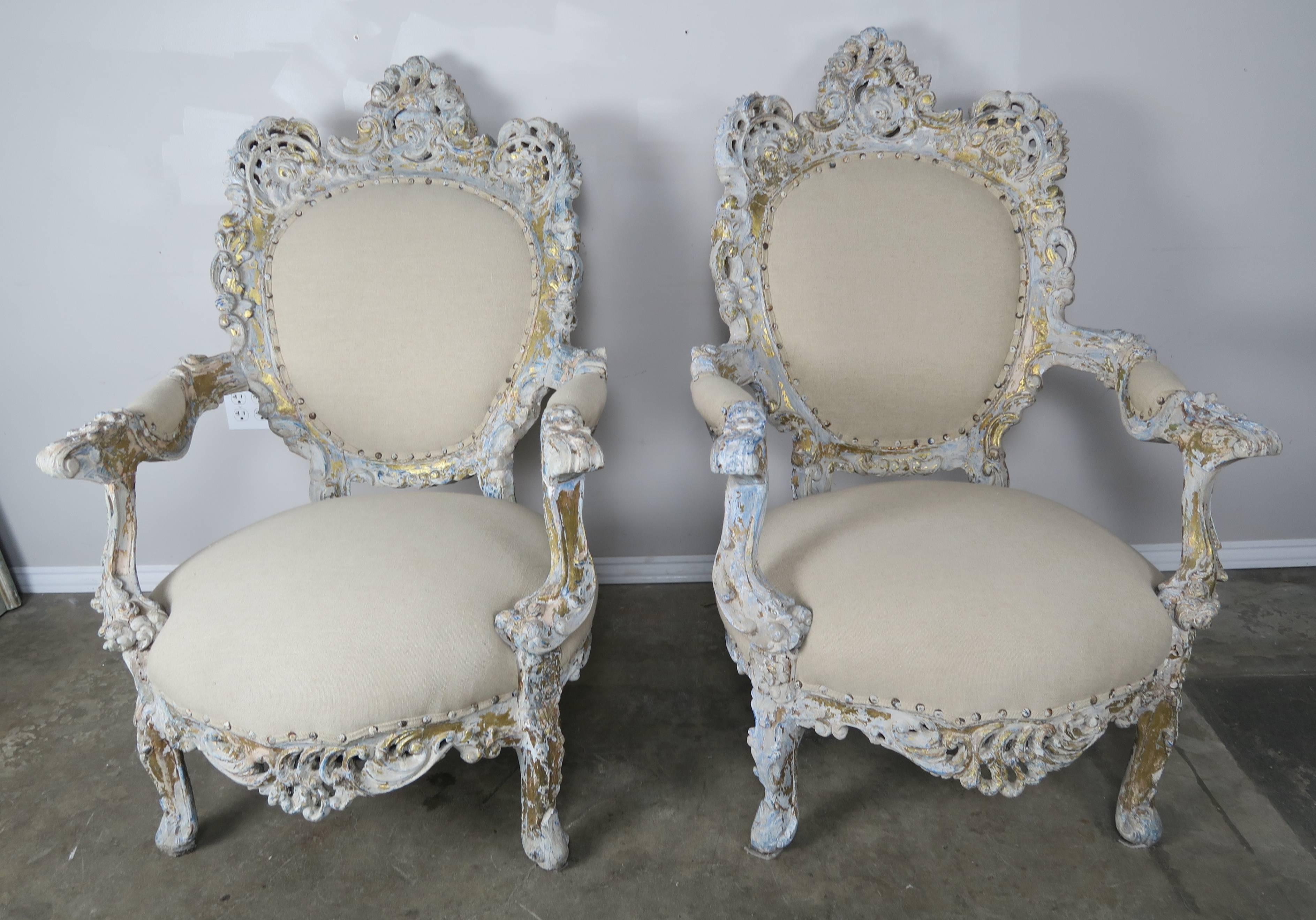 Pair of 19th century Rococo style French painted and parcel-gilt carved wood armchairs newly upholstered in a Pindler & Pindler 100% linen with the original spaced nailhead trim detail.