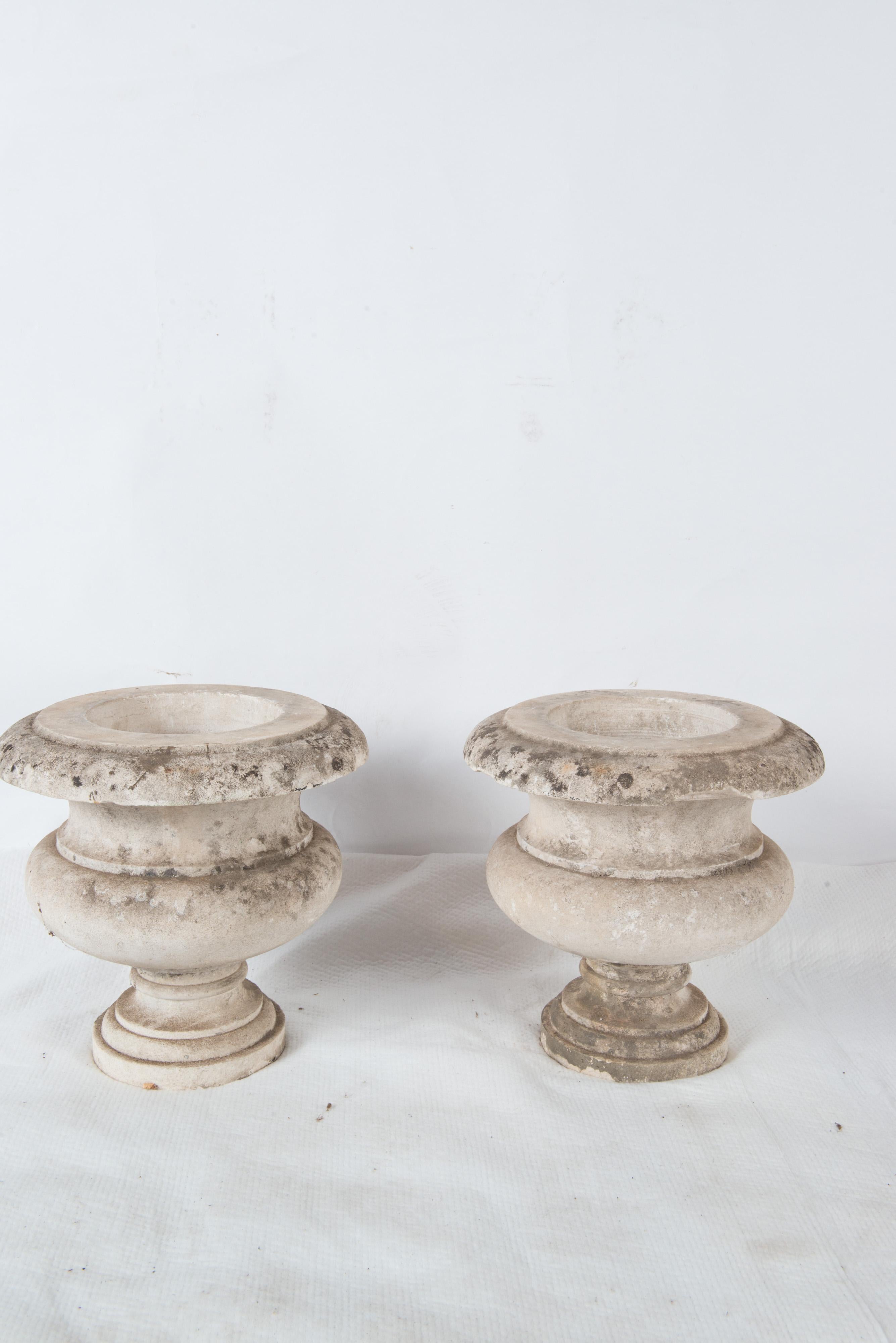 Pair of 19th century French carved stone planters or urns with circular bases. These are not cast stone.
Some losses to rims.
