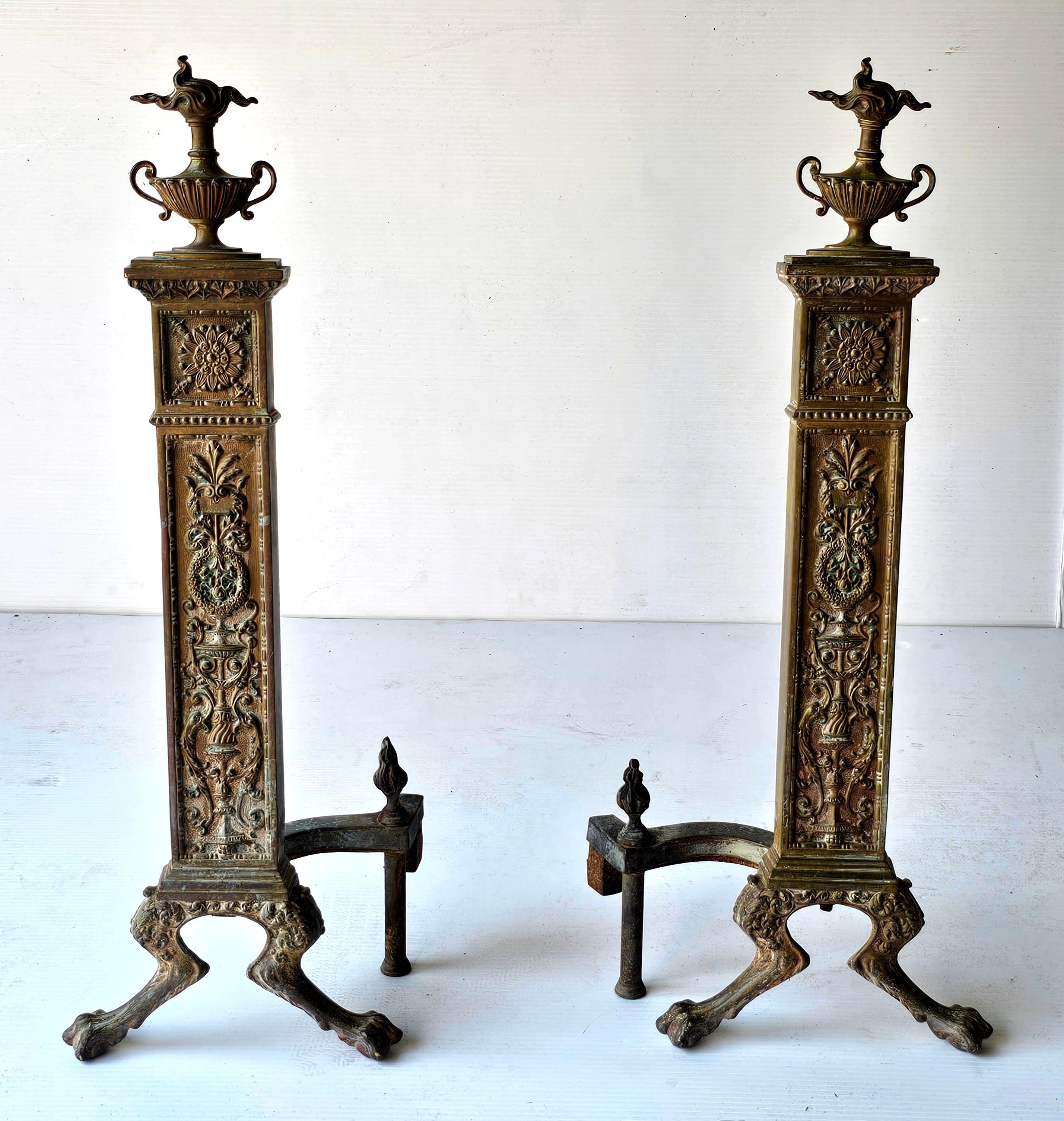 A 19th Century pair of  andirons, also known as firedogs. They are French Neoclassical bronze andirons. Andirons are used in fireplaces to support logs and improve airflow for the fire. 
Material: Bronze
Style: Neoclassical, featuring ornate
