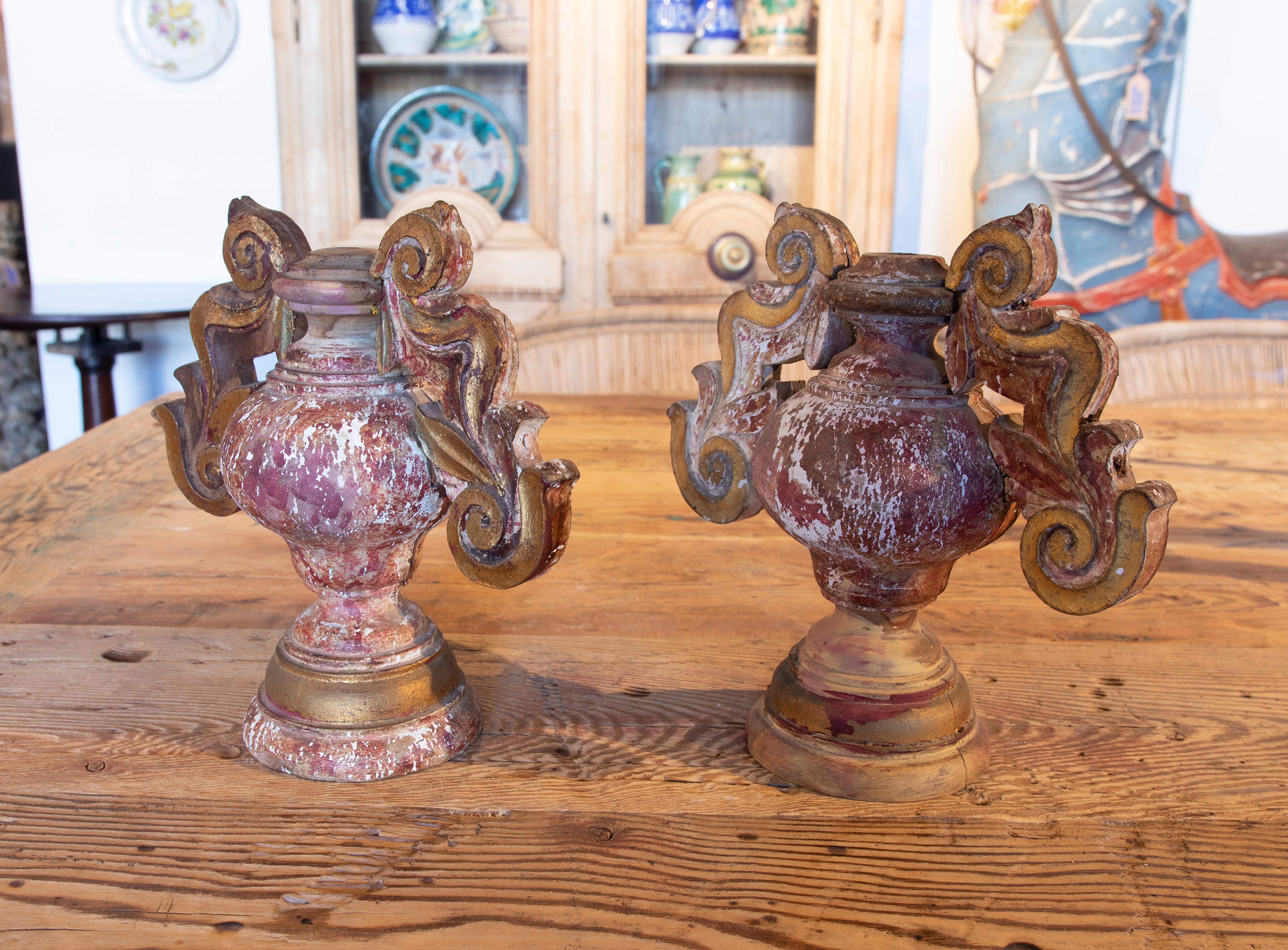 19th century pair of hand painted wooden finials in the shape of a vase with handles.
