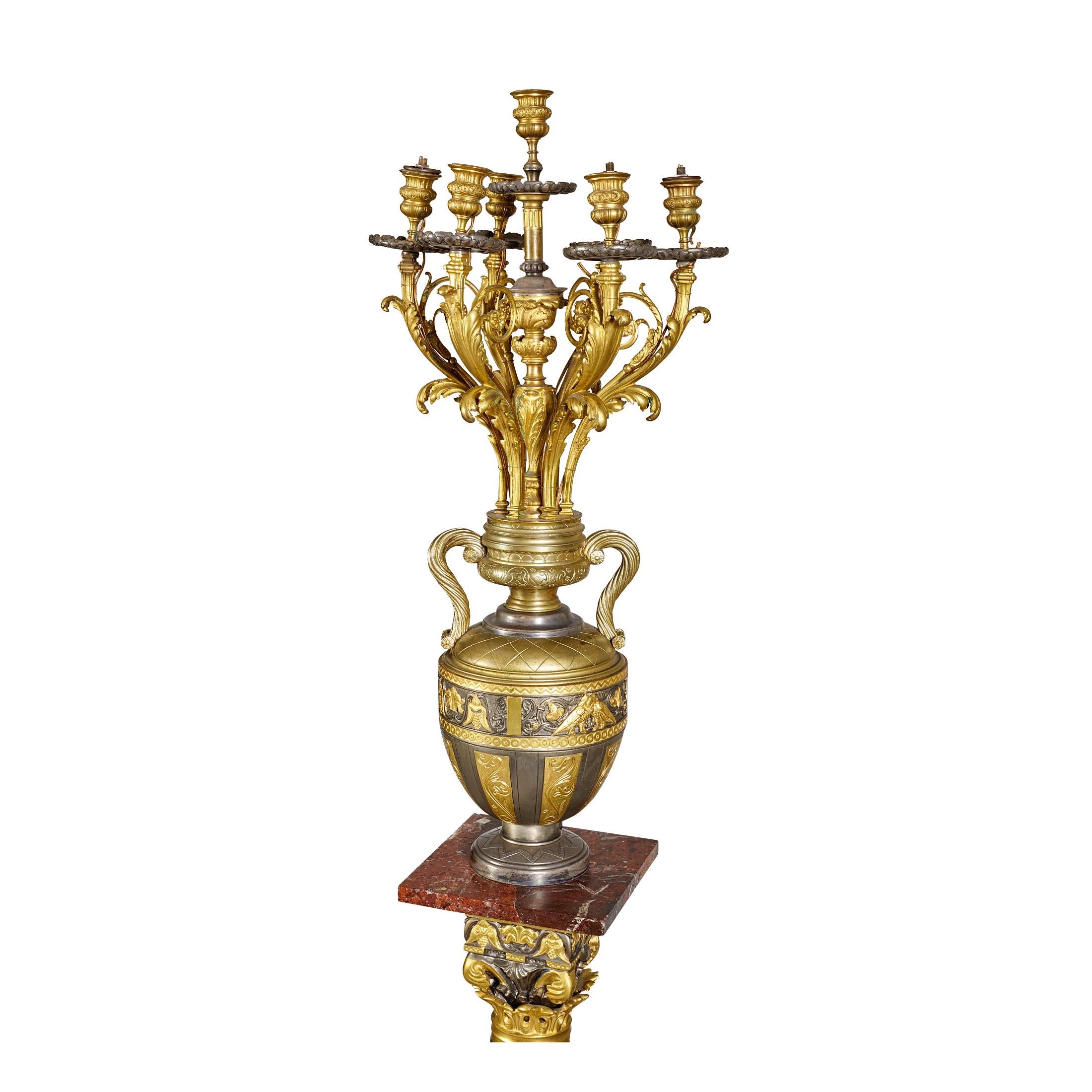 Highly important exhibition pair of 19th century large French gilt and silvered bronze candelabra on pedestal. The pair of candelabras on gorgeous Levanto rouge marble bases and formerly owned by MGM Studios.

Maker: Auguste Lacarrière Père, Fils et