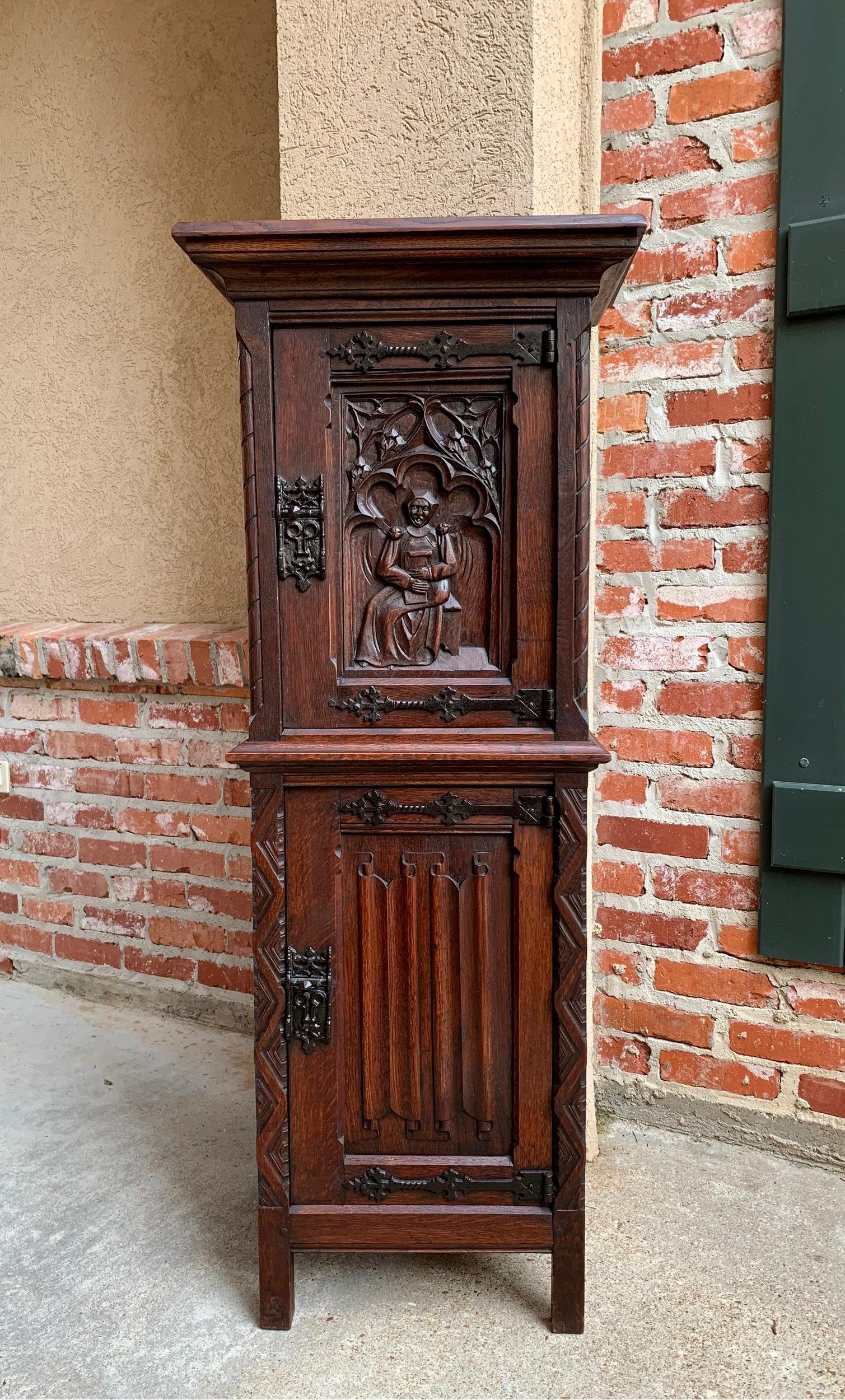 ~Direct from France~
~Super Petite antique French oak vestment/sacristy cabinet~
~Superb designs – look at the gorgeous dimensional carvings on the upper door panel…a sitting nun with Bible in hand, framed with carved gothic tracery~
~And