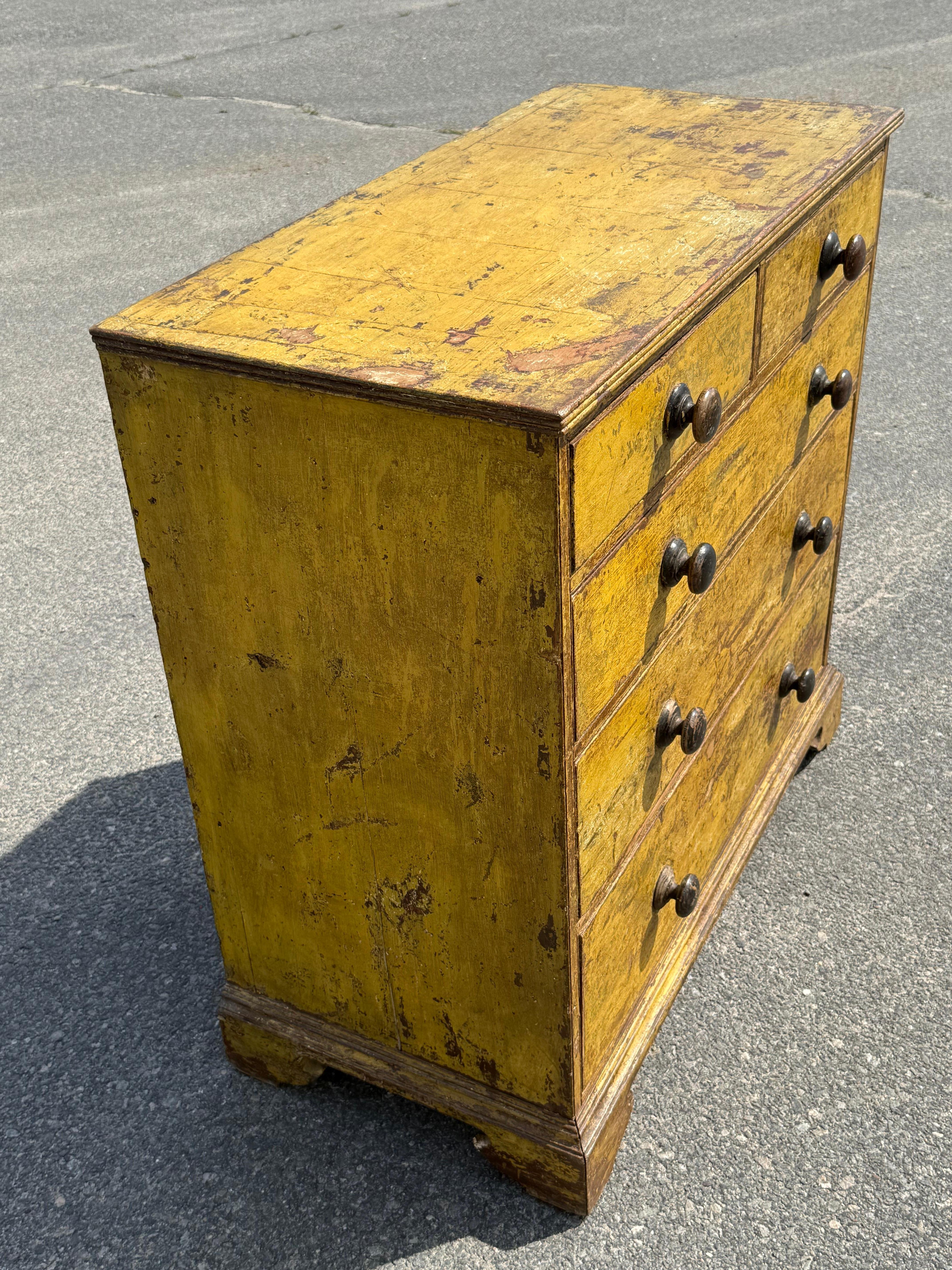 19th c. Pine two-over-three graduated chest of drawers in original mustard over red paint.  With reeded trim and bracket base. Canadian Maritimes.