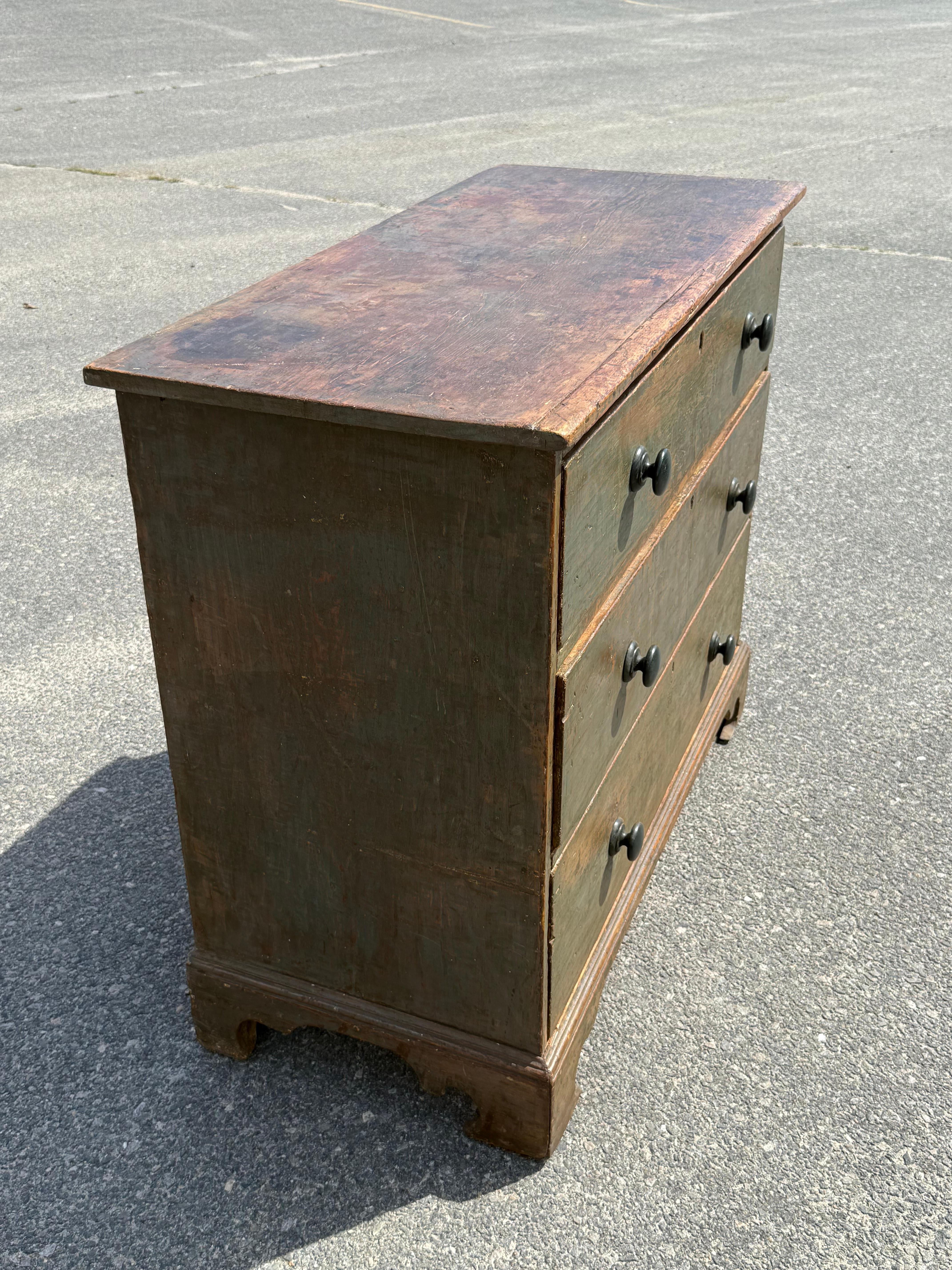 19th century Pine chest with three graduated drawers.  In original blue paint.  On ogee bracket base with sharp returns.  Ontario, ca. 1850.