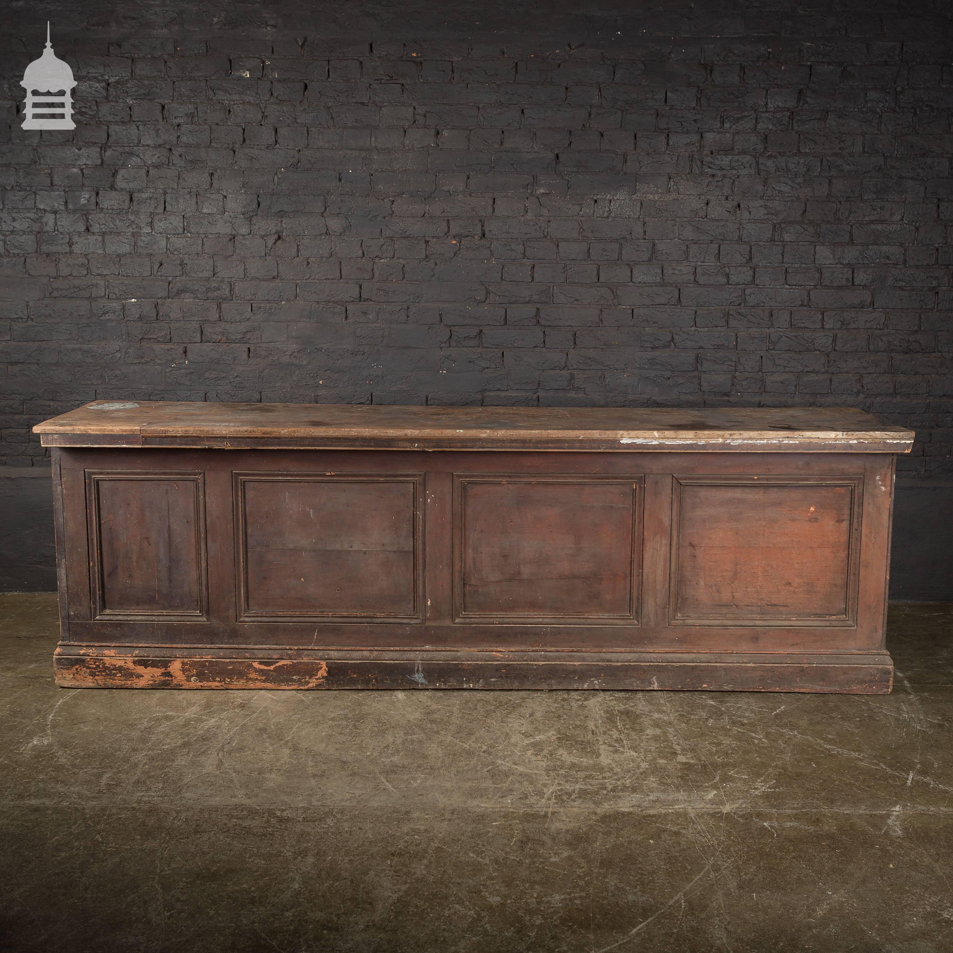19th century pine haberdashery shop counter with mahogany top and distressed paint finish.