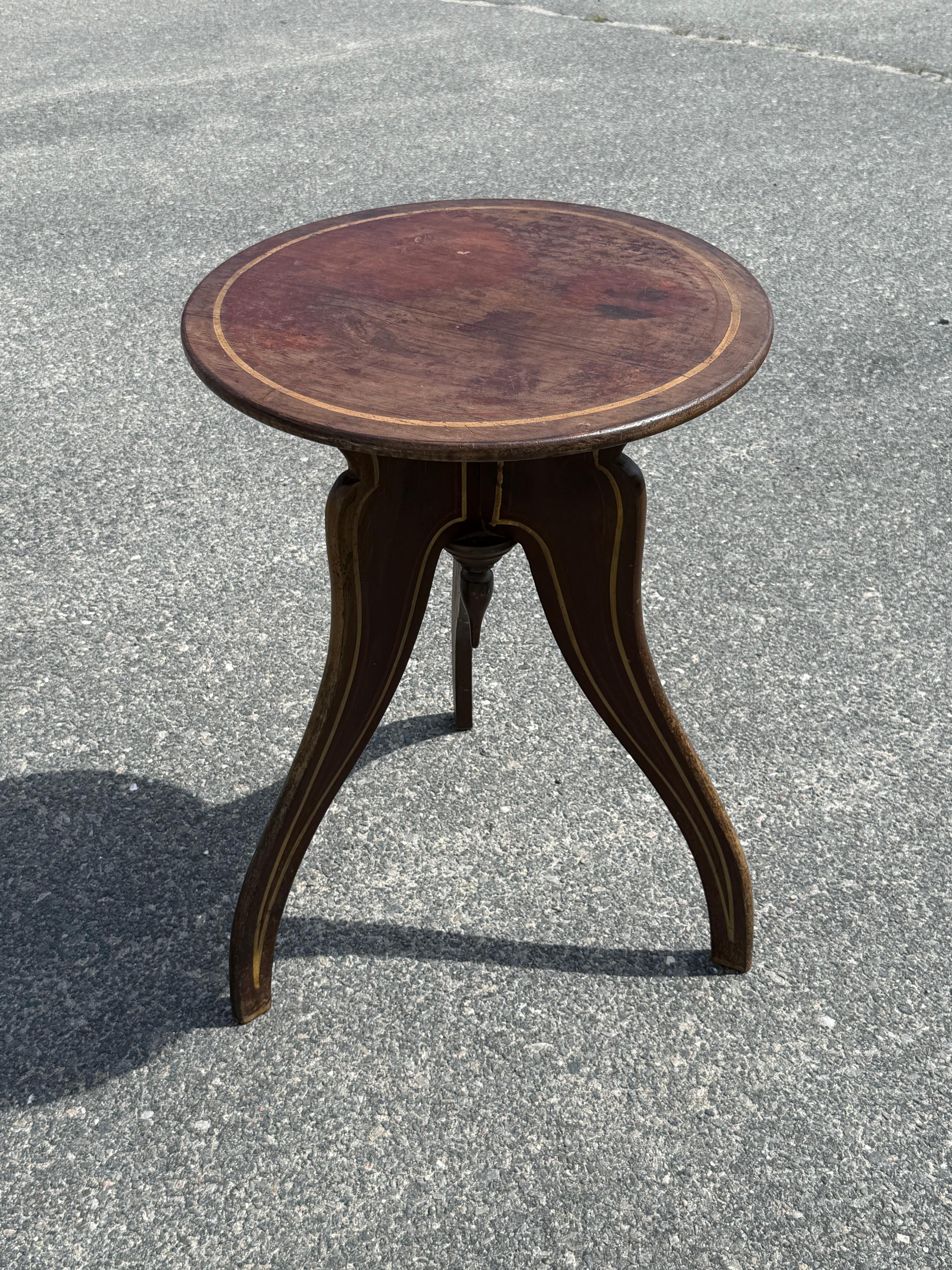 Tavolo a treppiede in pino del XIX secolo, verniciato in marrone originale con riflessi dorati su tutto il piano, con terminale a goccia sotto il piano, su gambe a sciabola sagomate.  Si trova sull'Isola del Principe Edoardo.