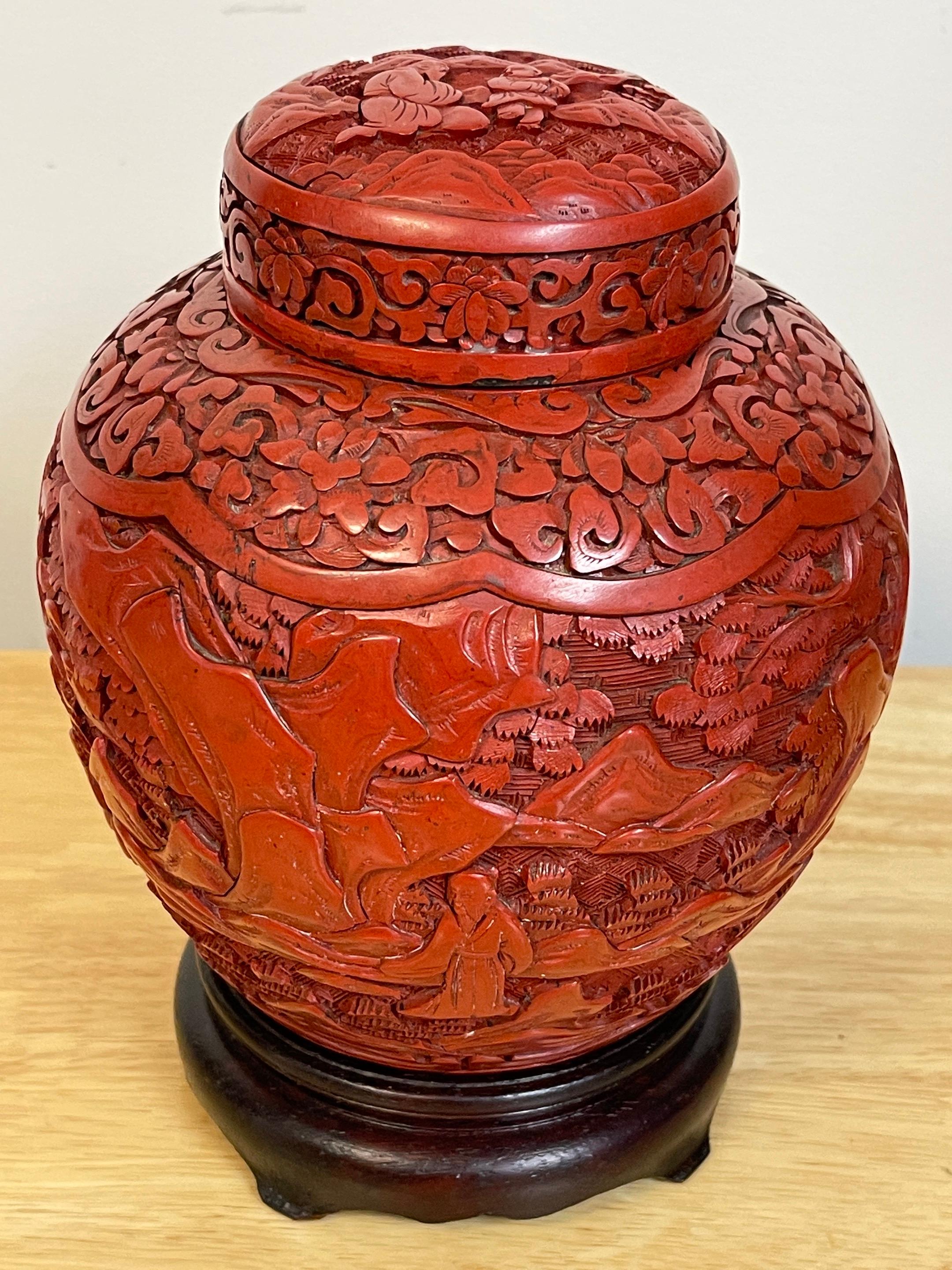 Post Qing Dynasty Cinnabar ginger jar & stand 
Exquisite high relief carved continuous landscape motif, complete with hardwood stand. Unmarked.
The ginger jar alone measures 7-inches high x 6-inches diameter x 3.5-inch diameter base 
On the stand
