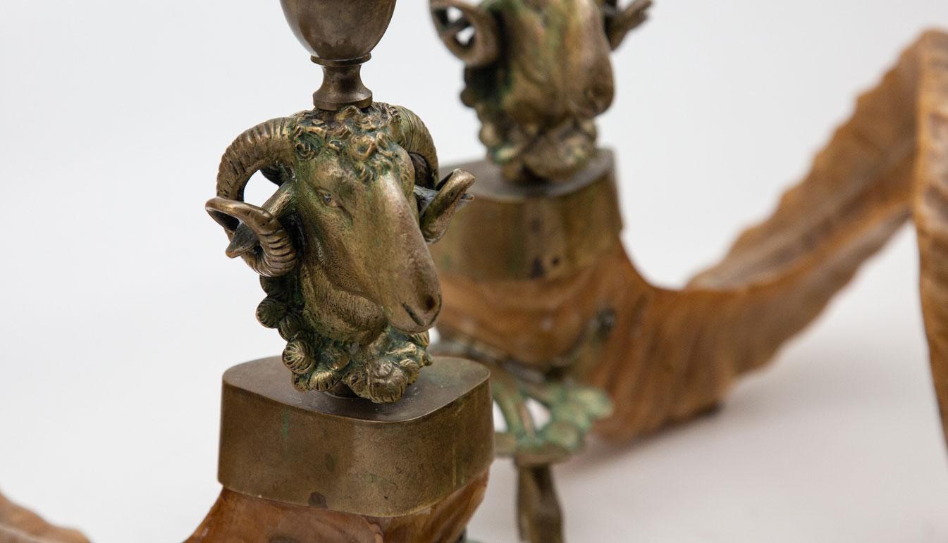19th century Ram's head and horn candlesticks. A pair of figural candleholders with bronze ram's head, hoofed feet, and natural ram's horn. Measures: 11