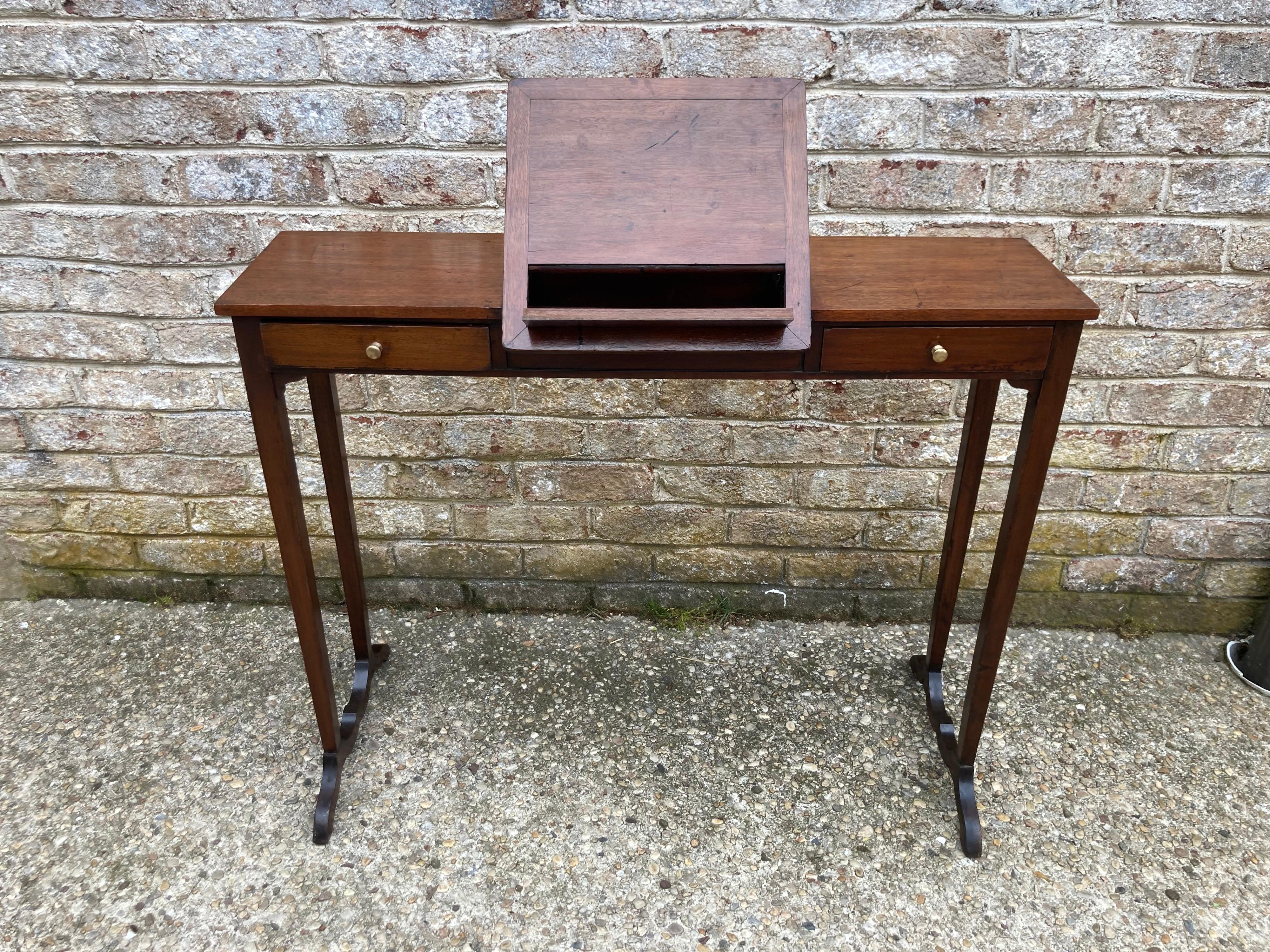 19th century reading stand and also narrow entry table or console. with two drawers and a pop up standing a very charming yet practical piece.