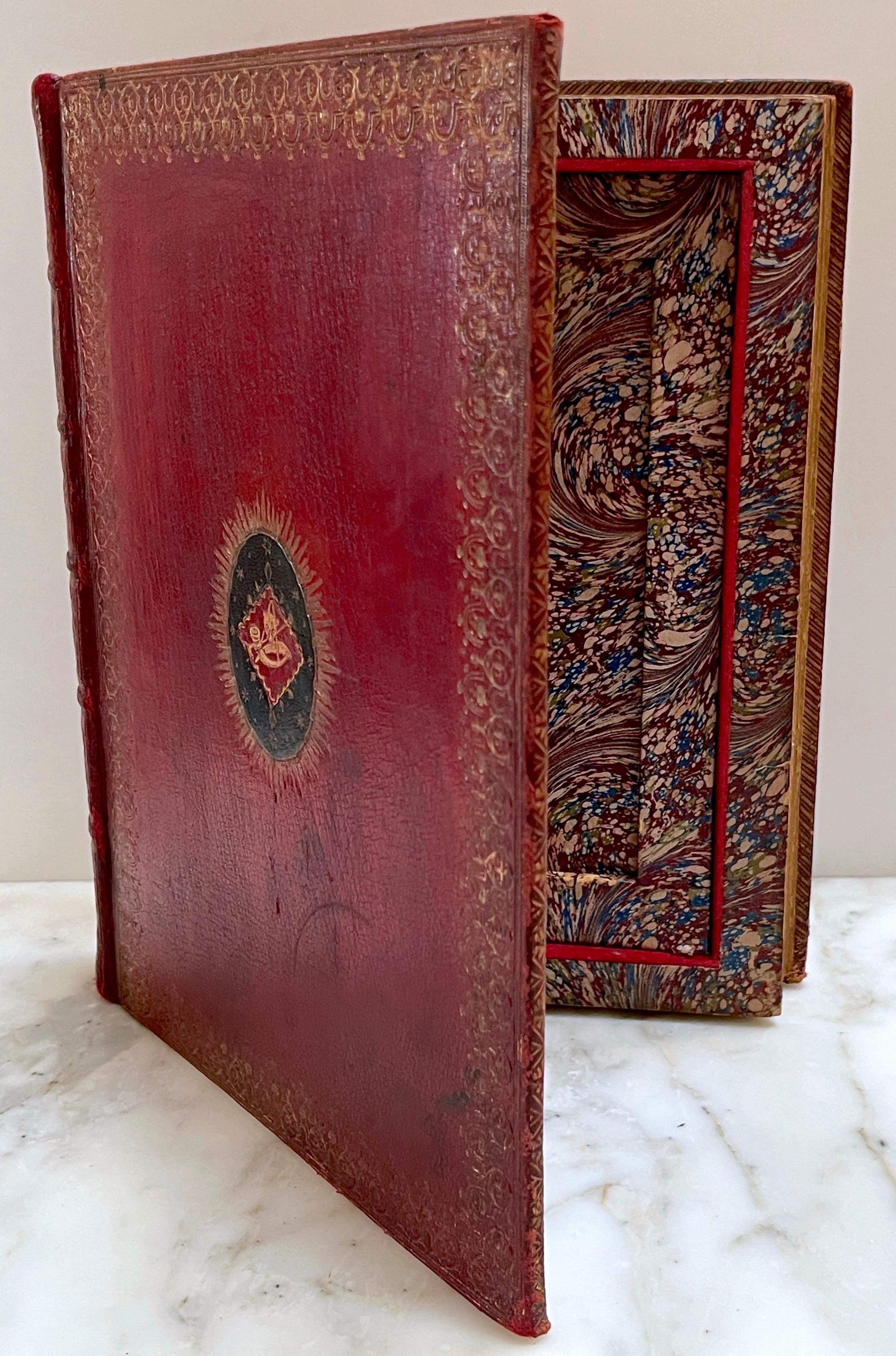 19th C. Red Embossed Leather Bound ( Faux / Dummy) Book Box 'Hunt Buttons' 
England, circa 1890s

This 19th-century red embossed leather bound book box, titled 'Hunt Buttons,' is a remarkable piece with both decorative and functional appeal. The