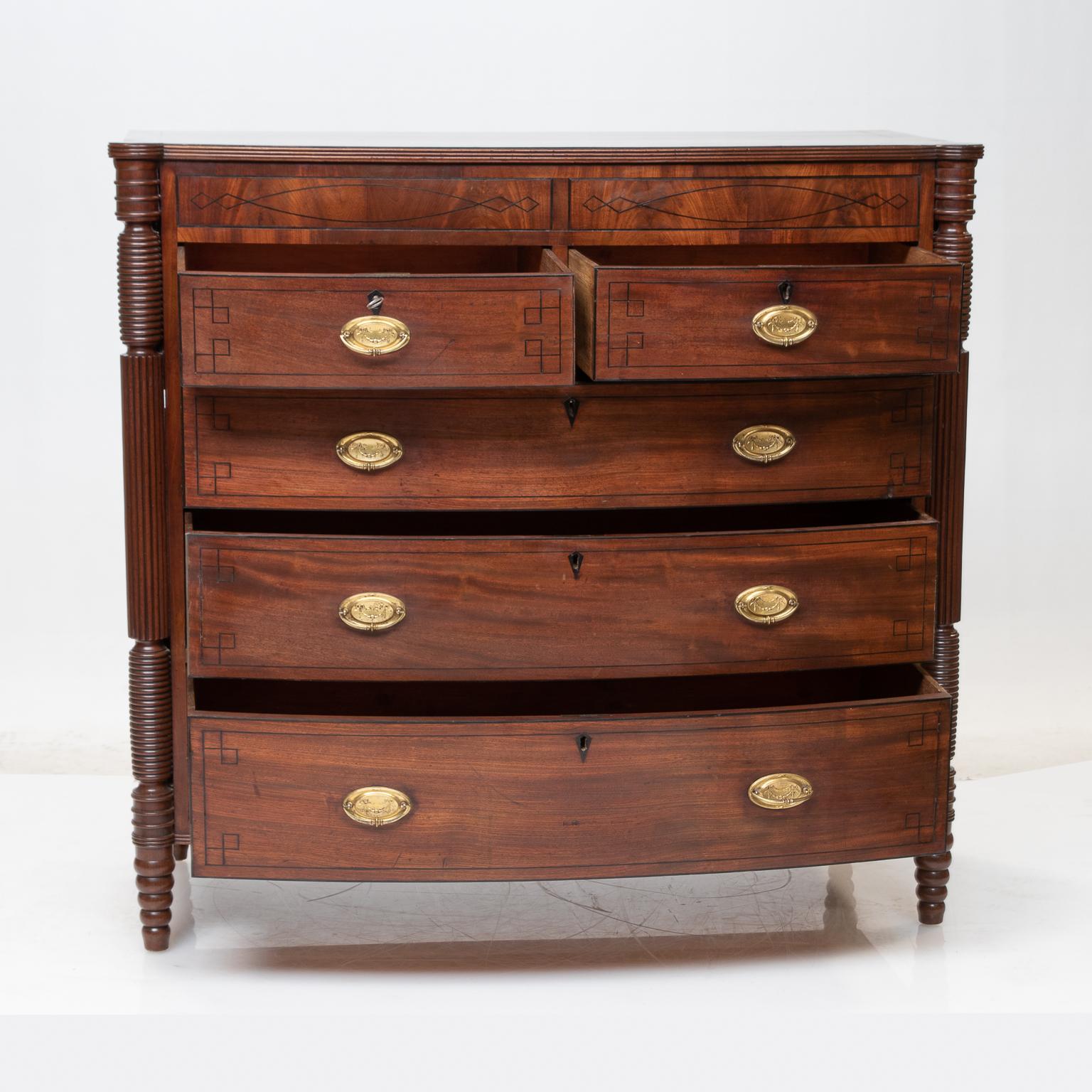 19th century regency chest of drawers
An elegant English regency mahogany chest of drawers. The chest detailed with intricate ebony string inlay, brass oval pulls, banded with choice flamed mahogany veneer's (the veneer is of thicker cuts of wood),