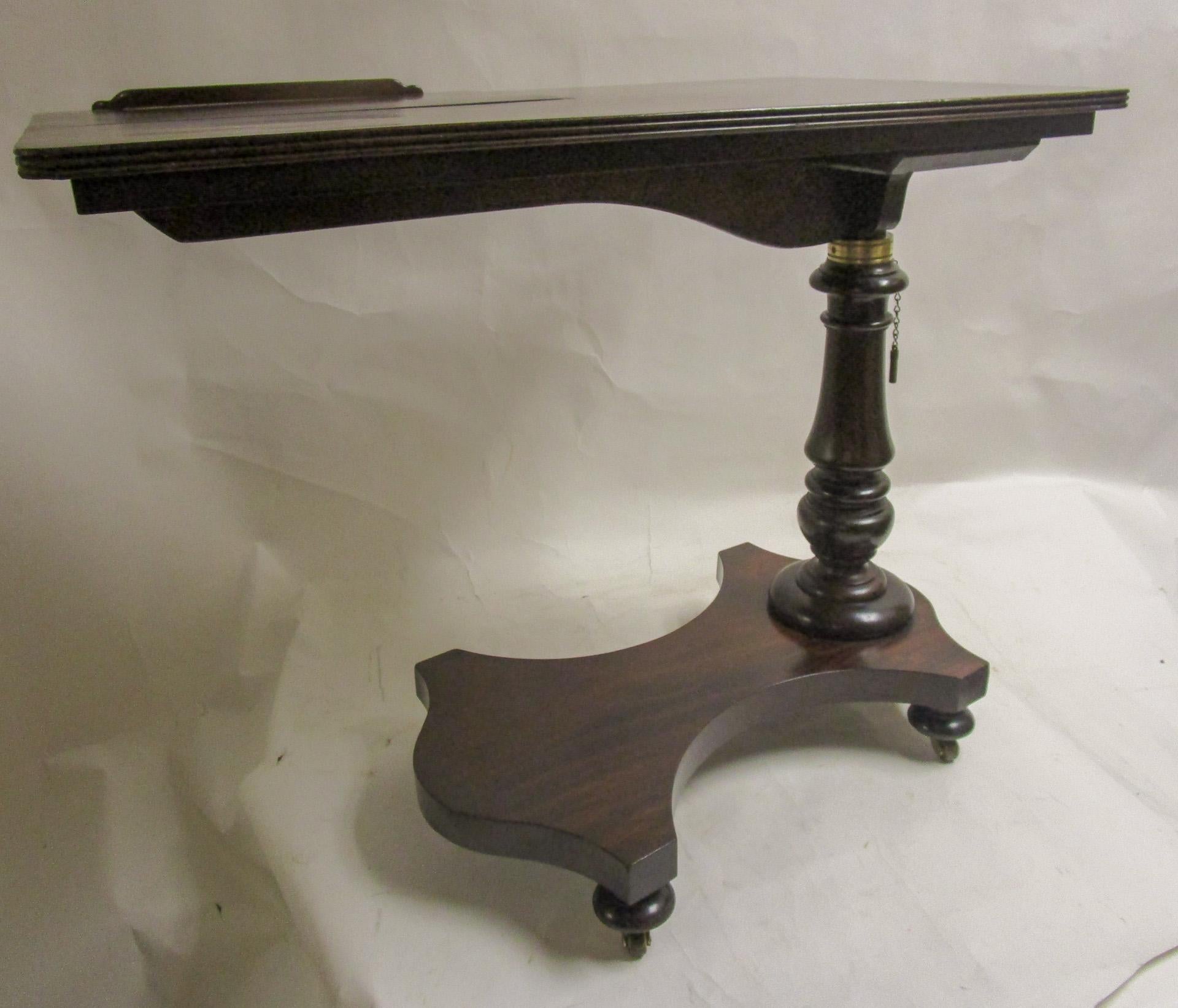 This handsome piece consists of two sections on a lifting ratchet, a fine mahogany Regency period reading/writing table featuring an adjustable top over a substantial base support. Retains the original mechanism to adjust the tray. The slanted book
