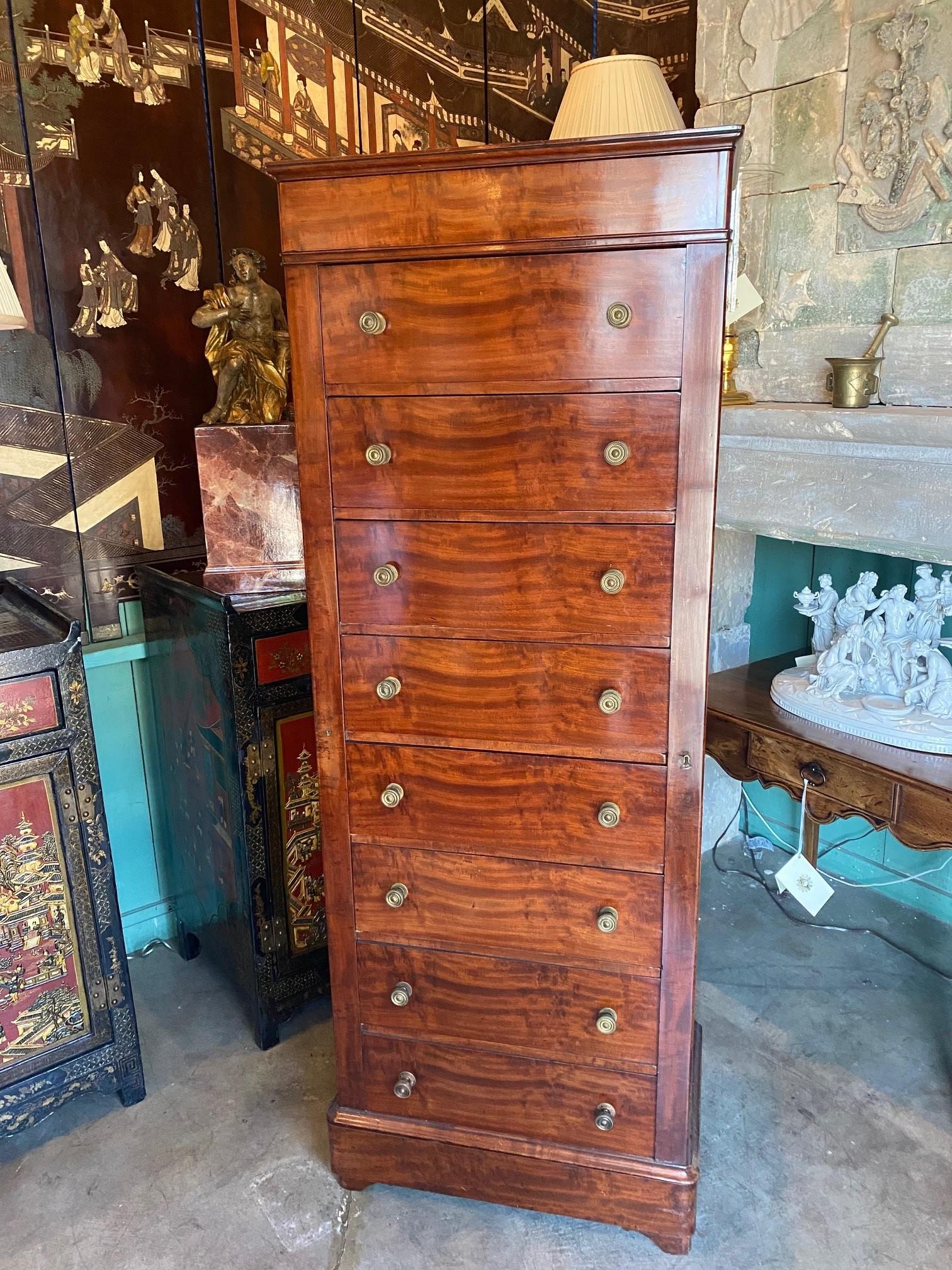 A tall and Elegant 19th Century Regency chest of drawers Mahogany Chiffonier also chiffonnier. Its name comes directly from a French piece of furniture , In British usage a chiffonier is similar to a sideboard , but differentiated by its smaller