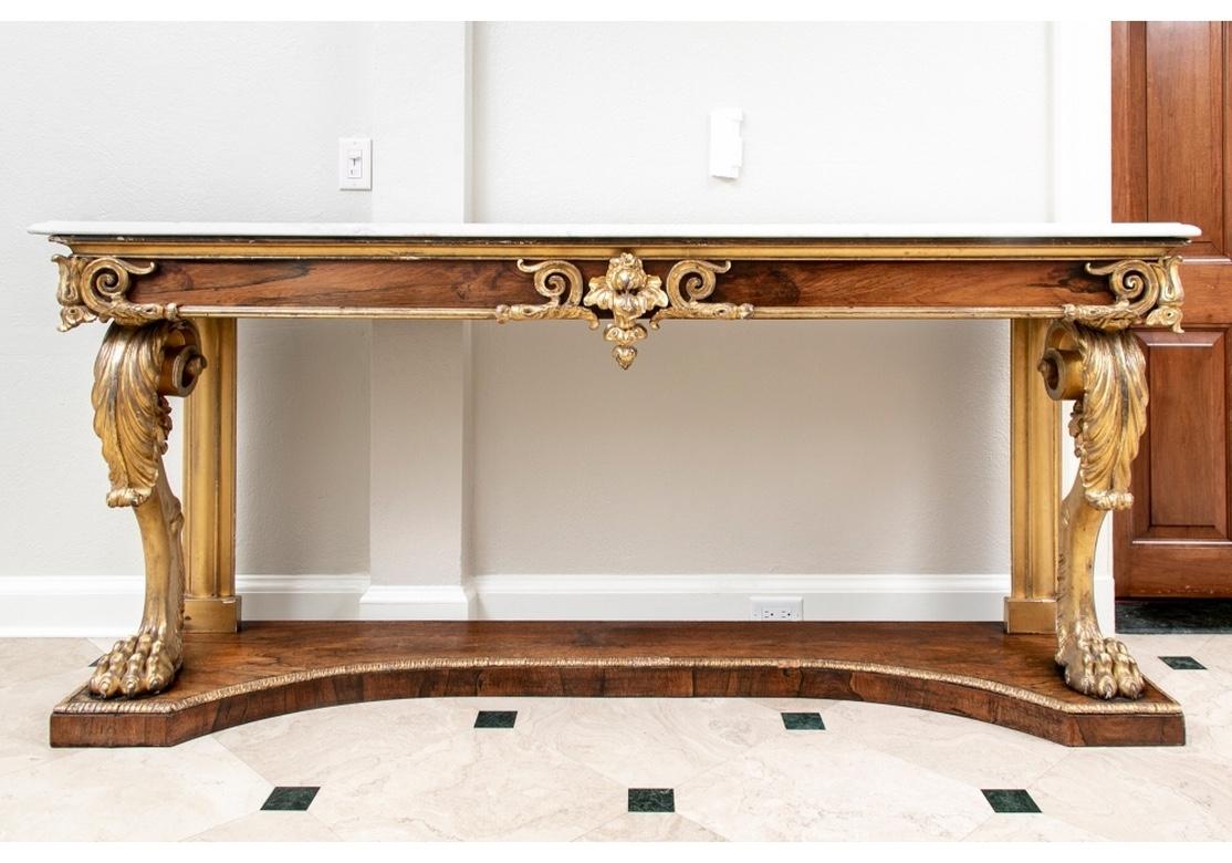 Acquired from White & Hewlett antiques and works of Art, New York City. Attributed to Marsh and Bailey, England circa 1835. With rosewood frieze and shaped lower tier, and carved and gilt details. The front and back ends of the frieze mounted with