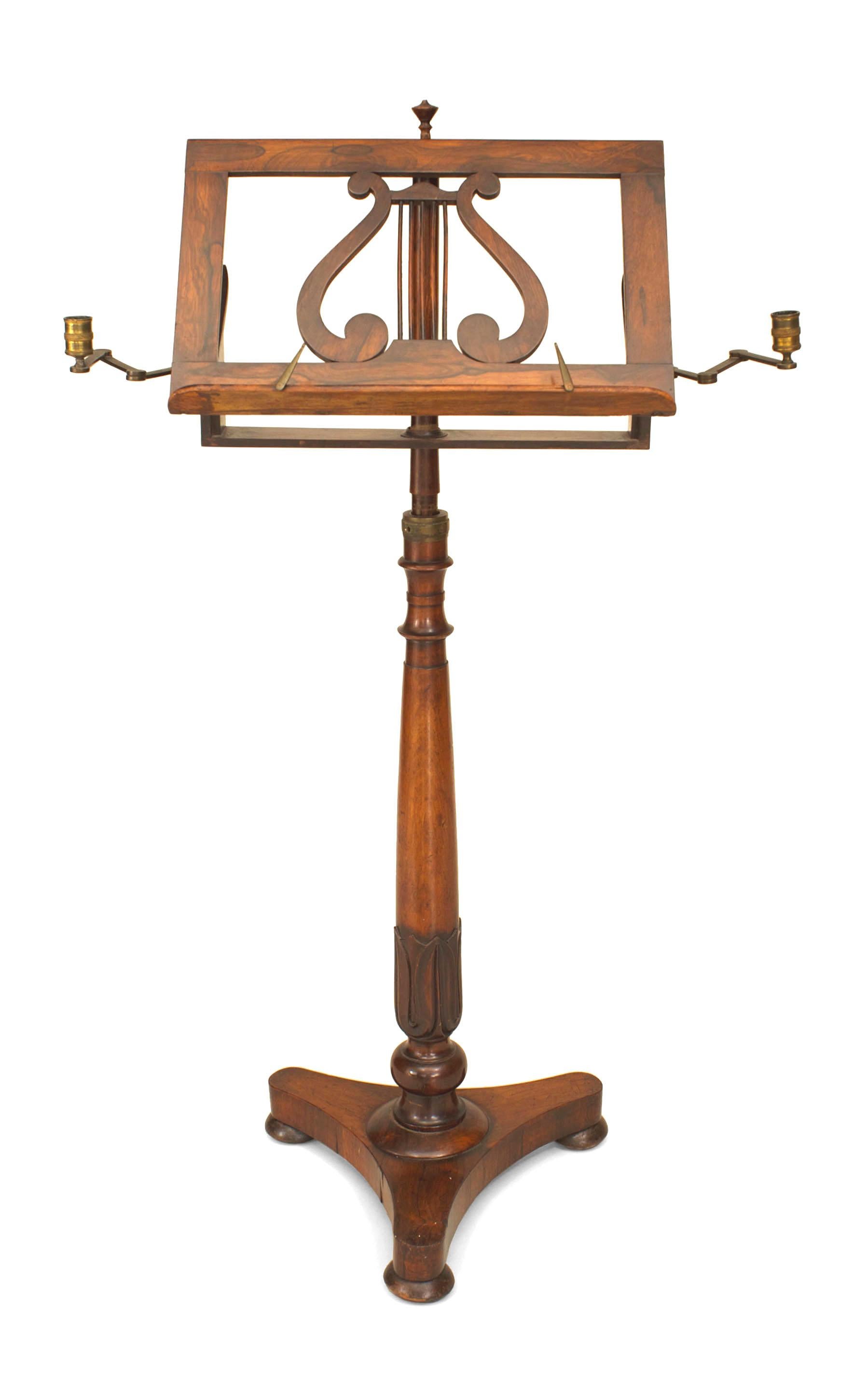 English Regency rosewood pedestal base music stand with an adjustable lyre design rack and 2 side telescoping brass candleholders.
