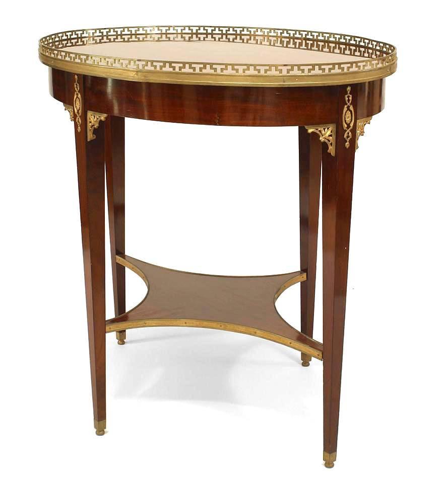 Russian Neoclassic (19th Century) ormolu mounted mahogany center table with pierced gallery around the oval top and legs joined by an undertier.
