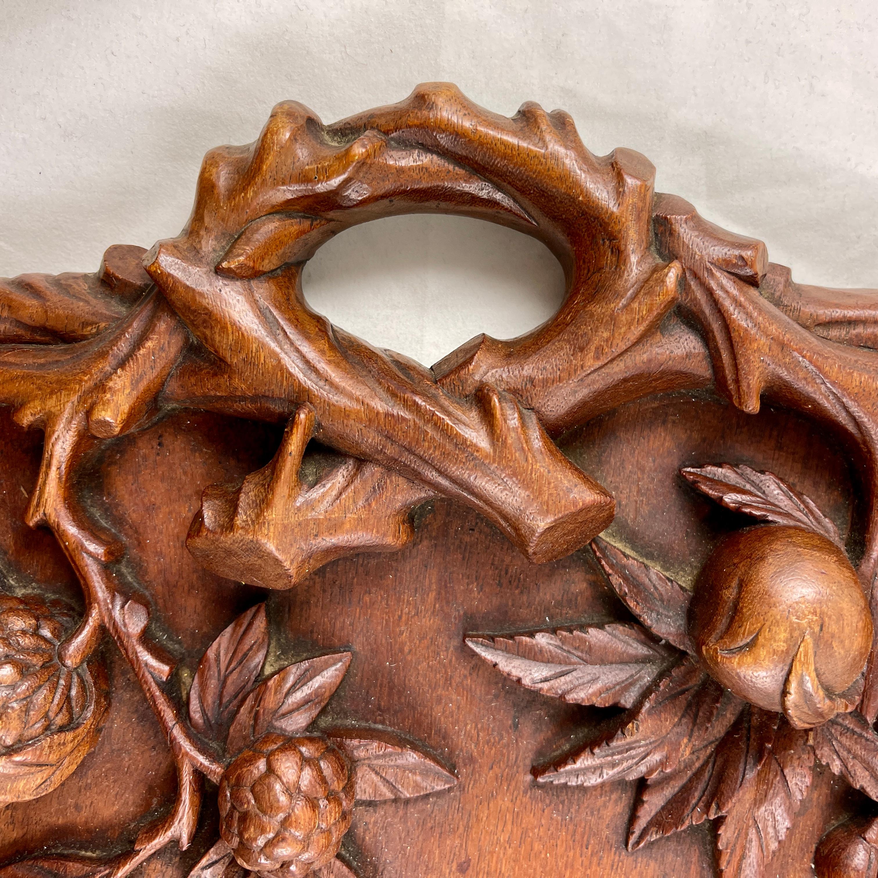 An exquisitely hand-carved Black Forest wooden serving tray, circa mid-late 19th Century.

A stunning, open handled tray showing branching exotic fruit – pomegranates, passionfruit, persimmons, and custard apples. The fruit is shown in clusters