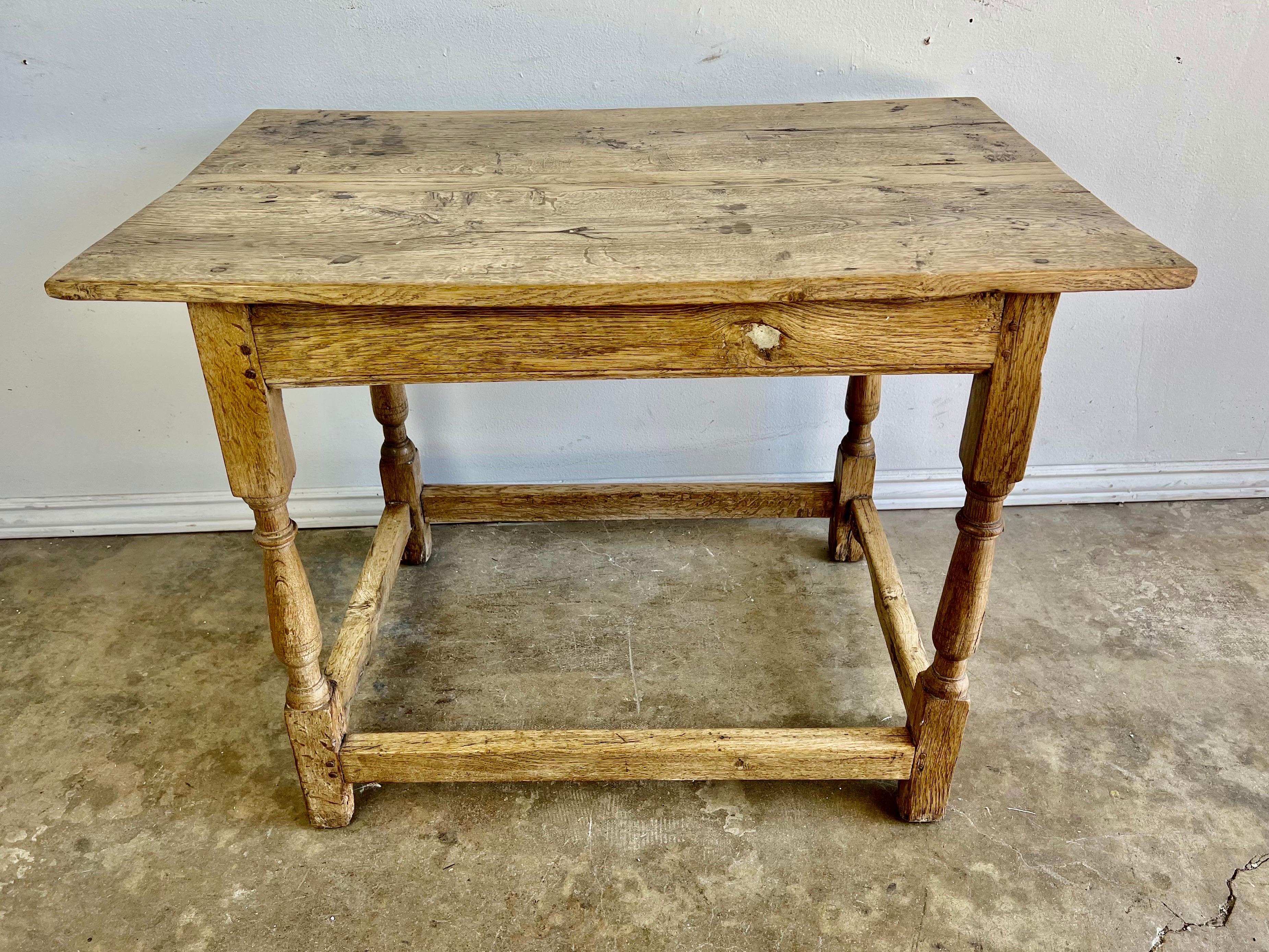 Rectangular shaped rustic bleached oak side table with bottom stretcher.