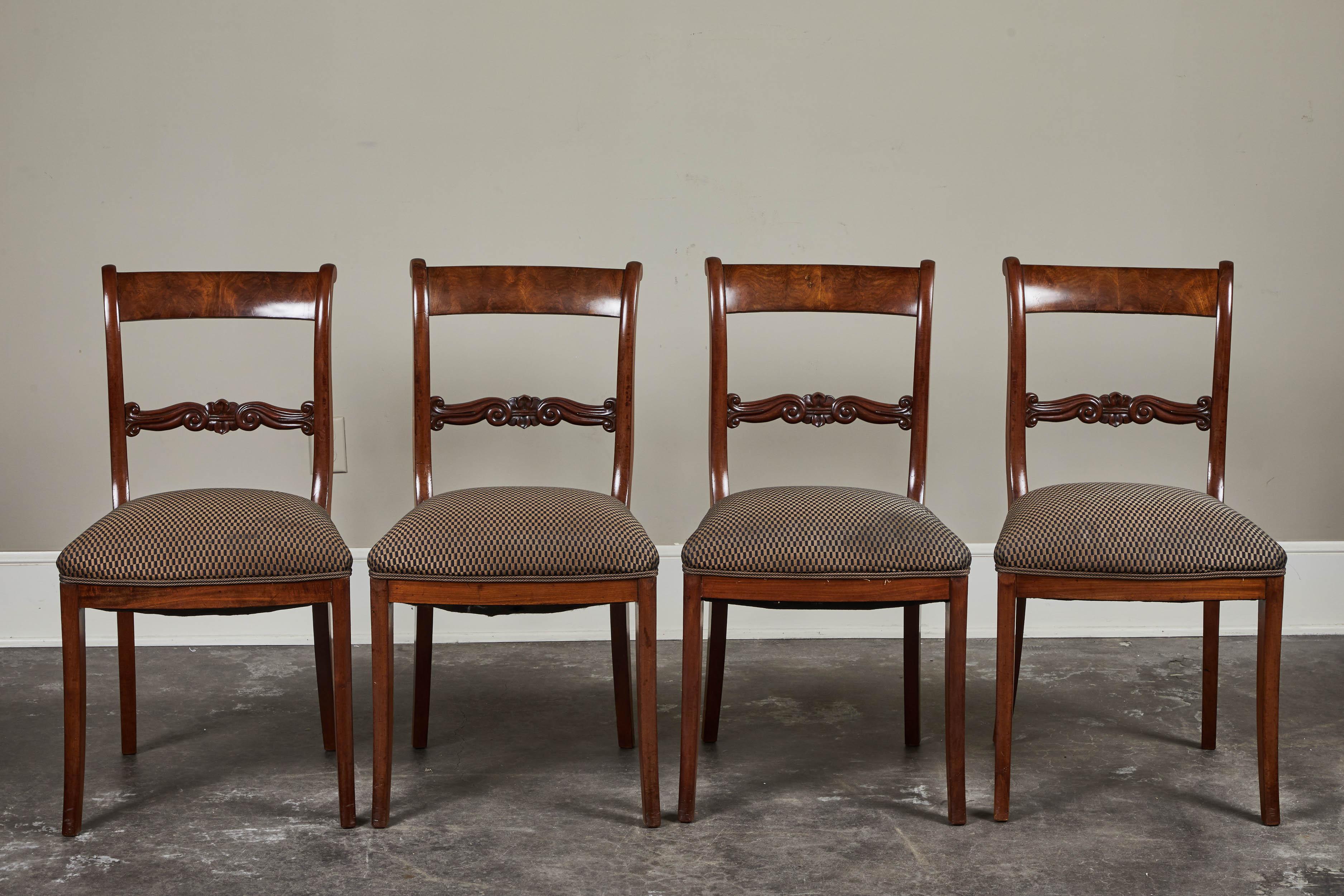 A set of six English mahogany dining chairs, circa 1840-1850. Pair of armchairs and four side chairs in this set. Rich mahogany with upholstered seats.