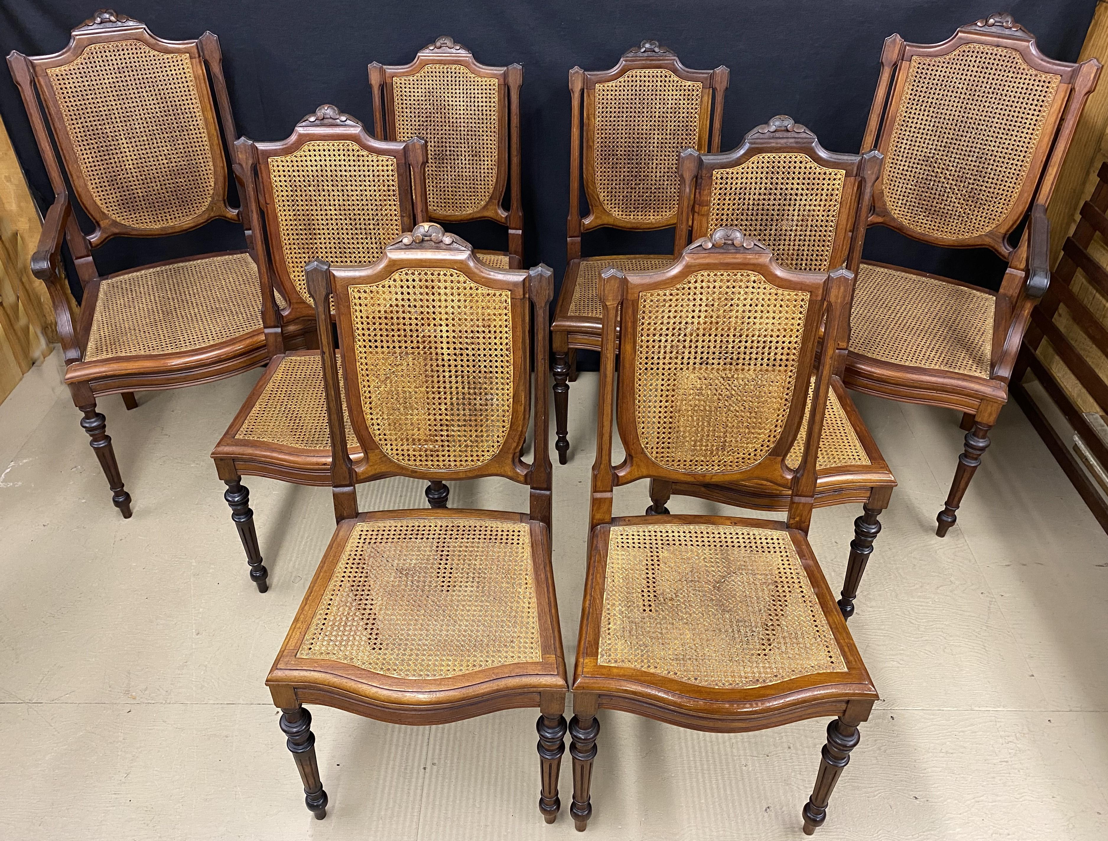 A fine set of eight Brazilian carved Jacaranda dining chairs, two arm chairs and six side chairs, with caned seats and backs, carved crests, shaped seat rails, and tapered round turned and reeded legs. Each chair comes with a reversible custom
