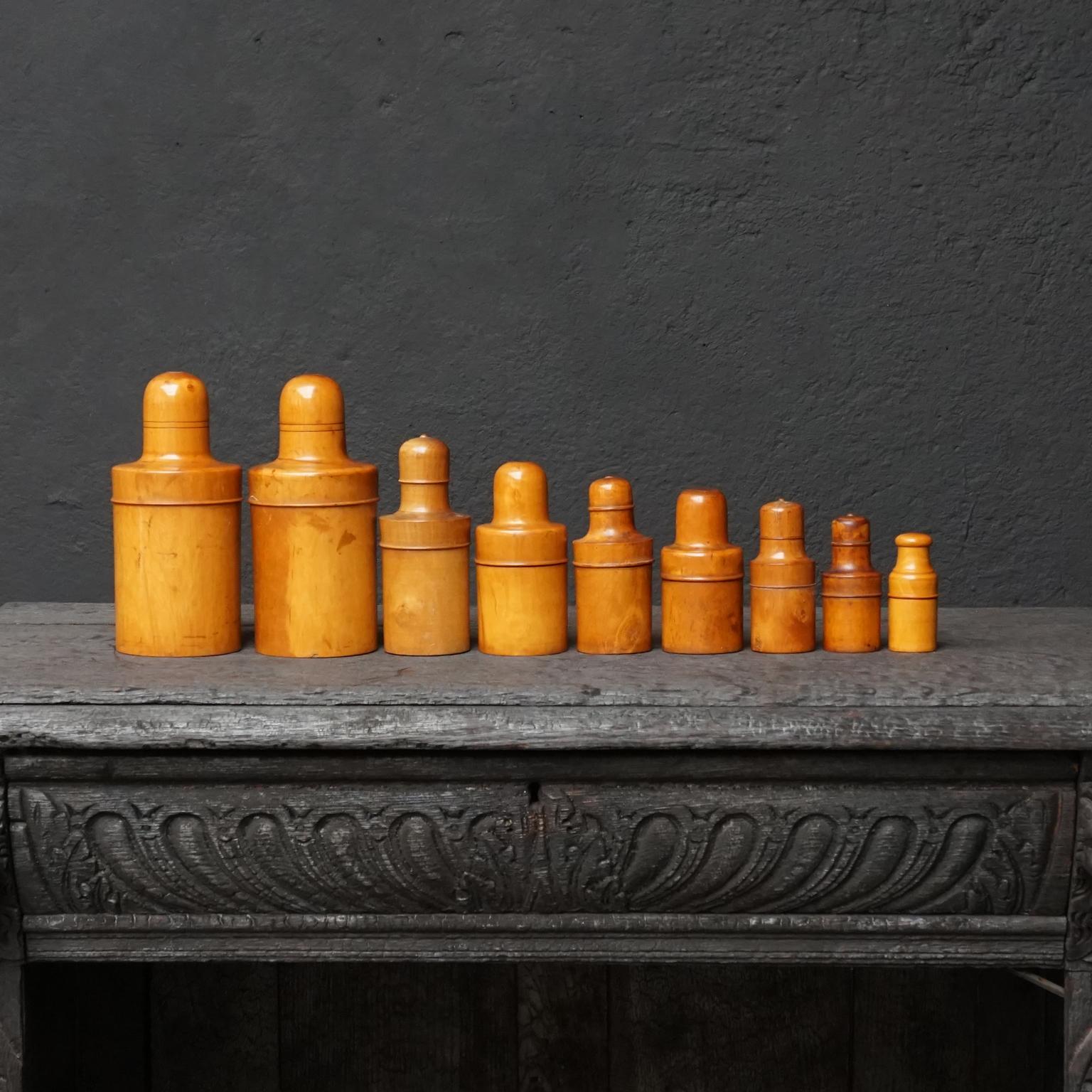 A set of nine 19th century Victorian treen turned boxwood medicine bottle holders. 
These containers were used for protecting delicate items such as glass apothecary bottles, perfume bottles, syringes, powder, ointment bottles, thermometers and