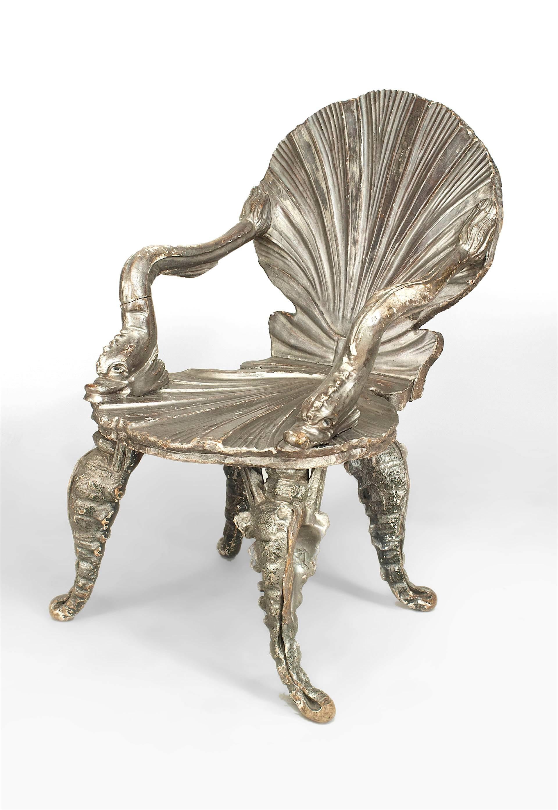 Late nineteenth century Venetian grotto style silver gilt armchair with a carved shell form seat and back with dolphin arms and four curved, marine-inspired legs.