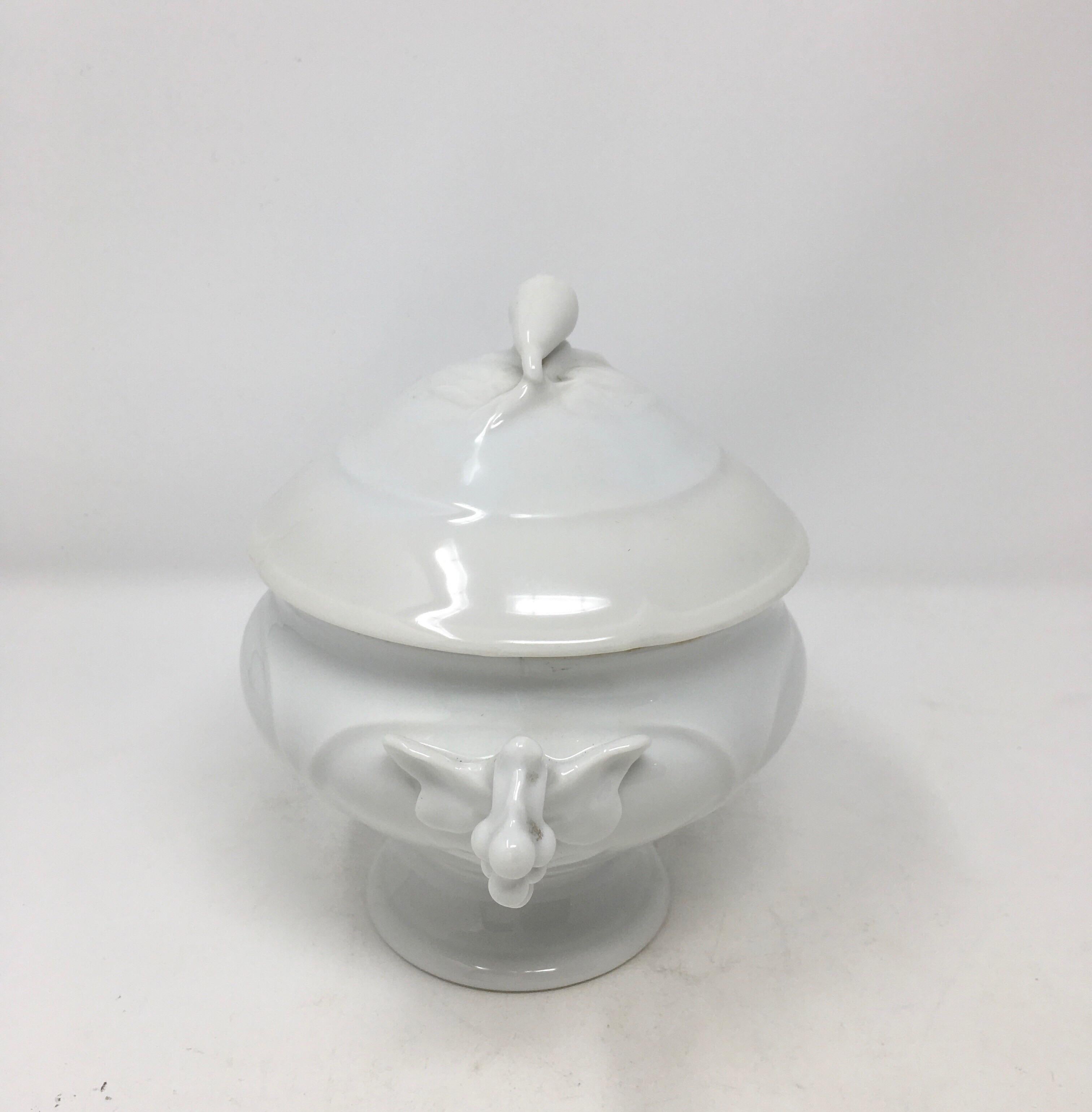 A gorgeous 19th century small glazed, white ironstone soupier from France. The soupier sits on a pedestal base and is complete with two ornate handles and a stylish lid that features a decorative pull handle. With its beautiful antique glazed finish