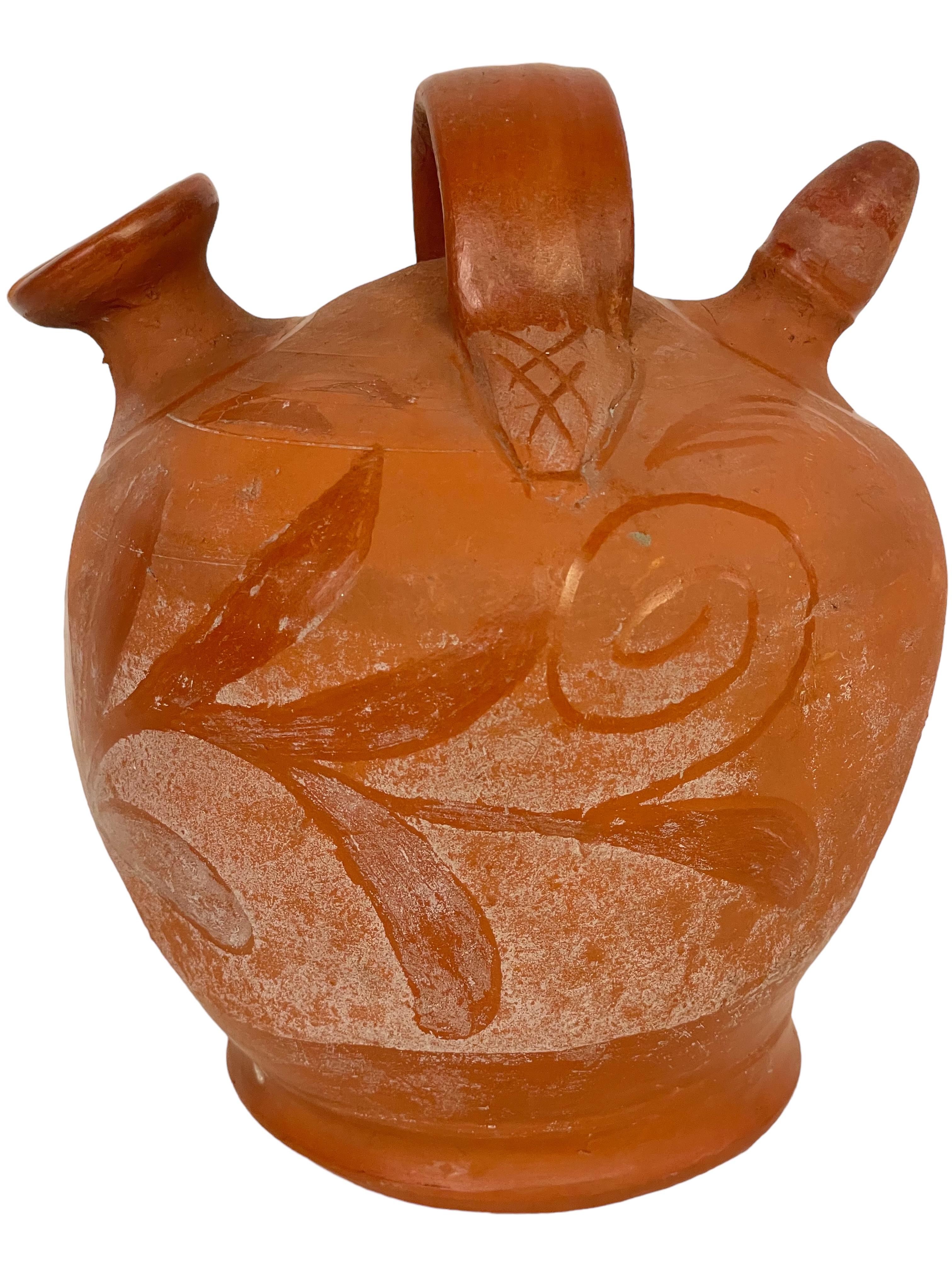 This handmade terracotta 'botijo' is a traditional unglazed Spanish jug, the ancient and ingenious design of which has been perfected over centuries for the cooling and serving of fresh drinking water. Shaped in the time-honoured way, with a gently