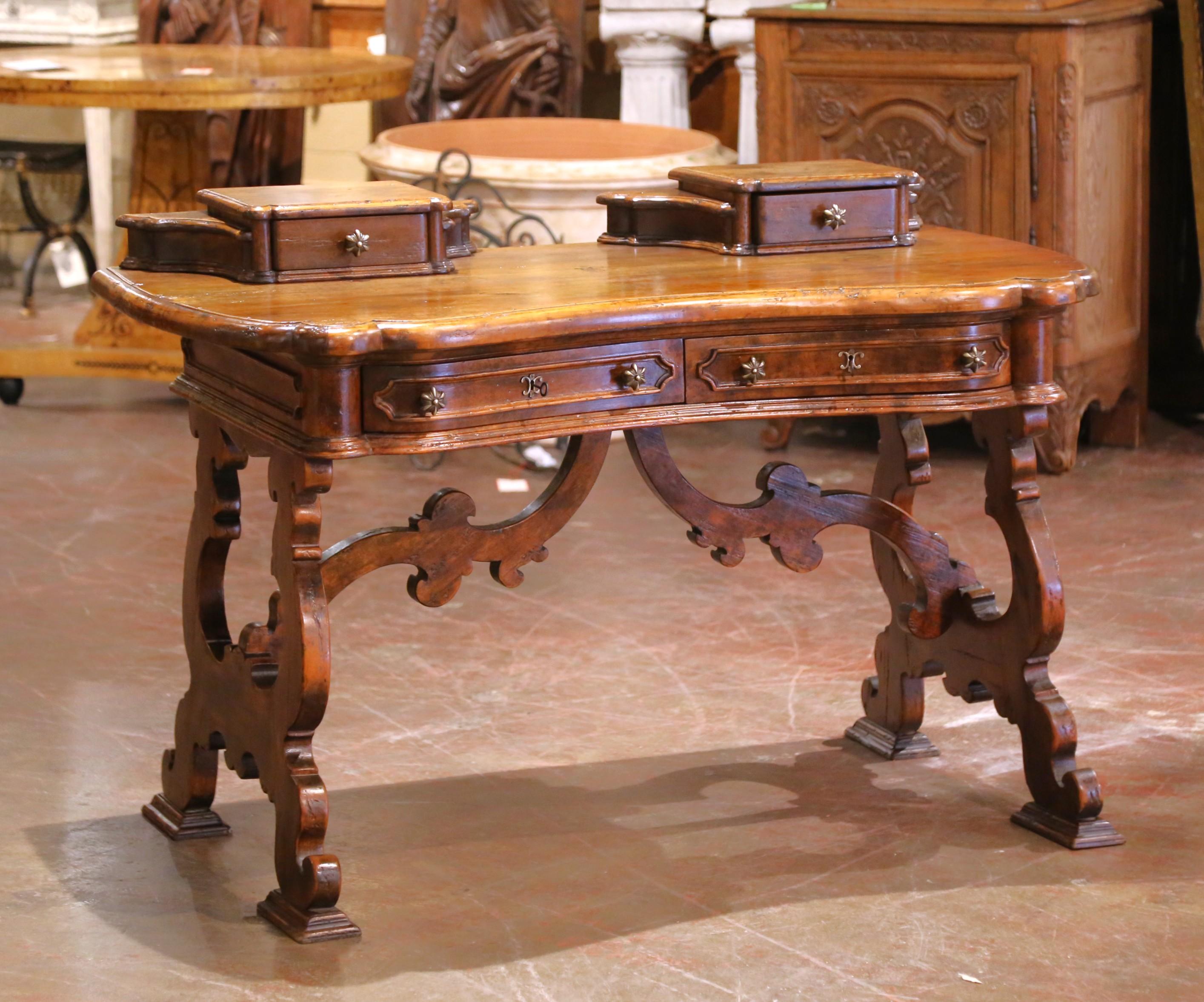 Crafted in Spain circa 1860, this sculptural antique walnut writing desk exemplifies the bold elegance of 19th-century Spanish craftsmanship. The serpentine front adds a graceful silhouette, while the molded top features two raised, shaped
