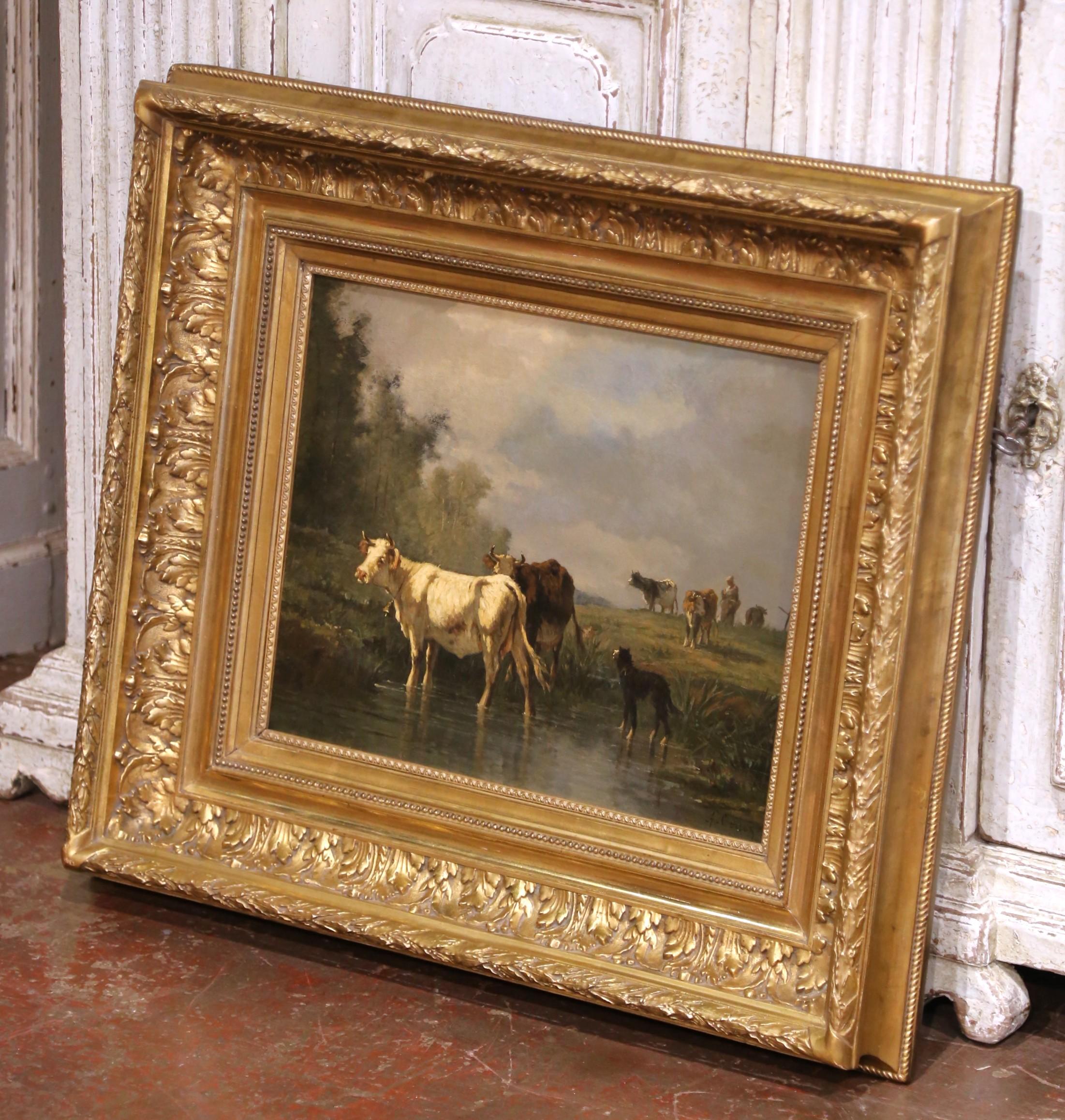 Questo eccezionale dipinto a olio del XIX secolo raffigura una tranquilla mandria di bovini che si abbevera lungo un ruscello ombreggiato, accompagnata da un cane da pastore solitario sotto un cielo drammatico. Firmata A. Cortes in basso a destra,