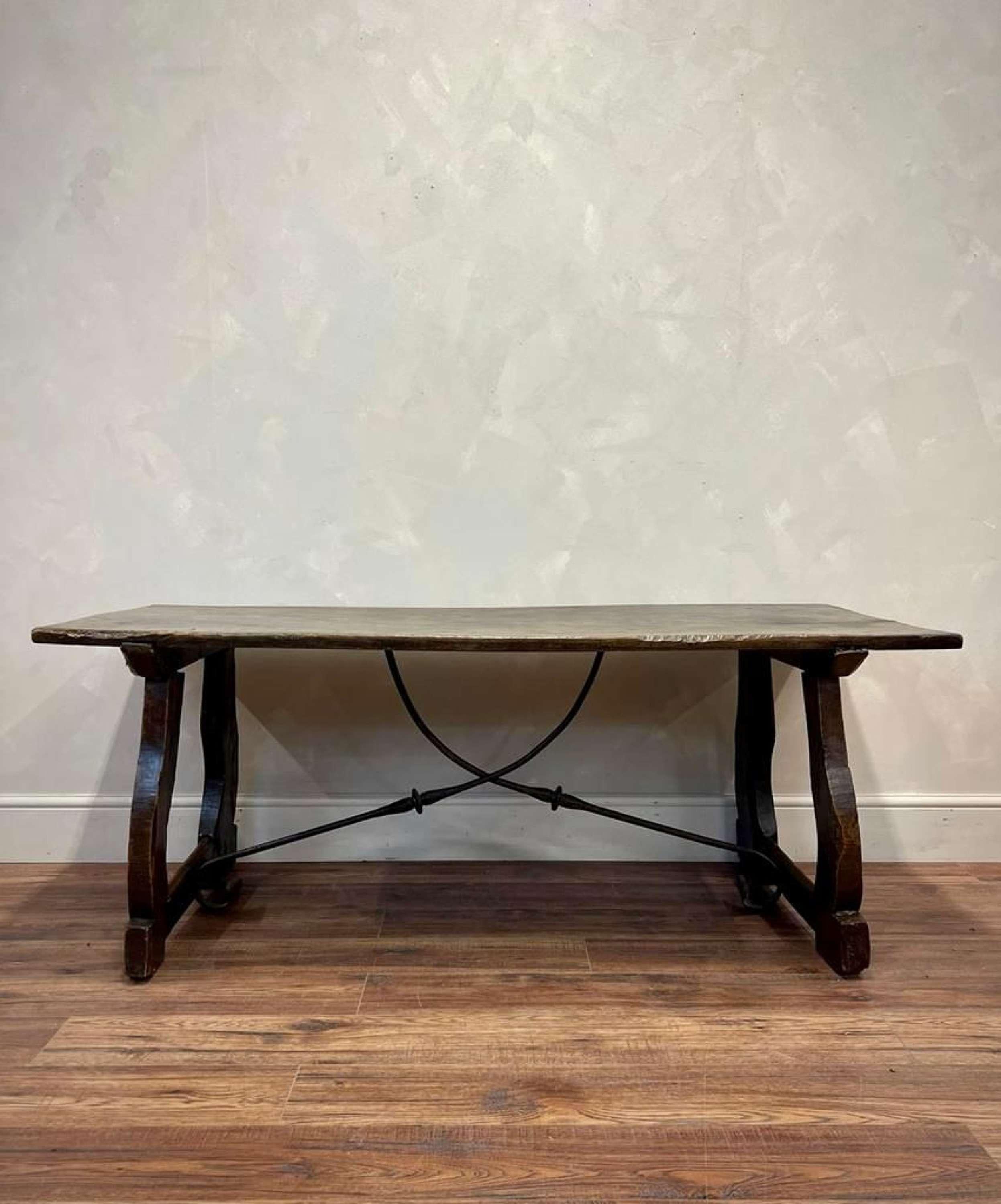 Beautiful hand carved Spanish walnut table with iron stretchers 
Carved lined detail to the legs 
General wear with age to the sides as shown 
This would work well as a console against the wall or behind a sofa 
This piece has been left as natural