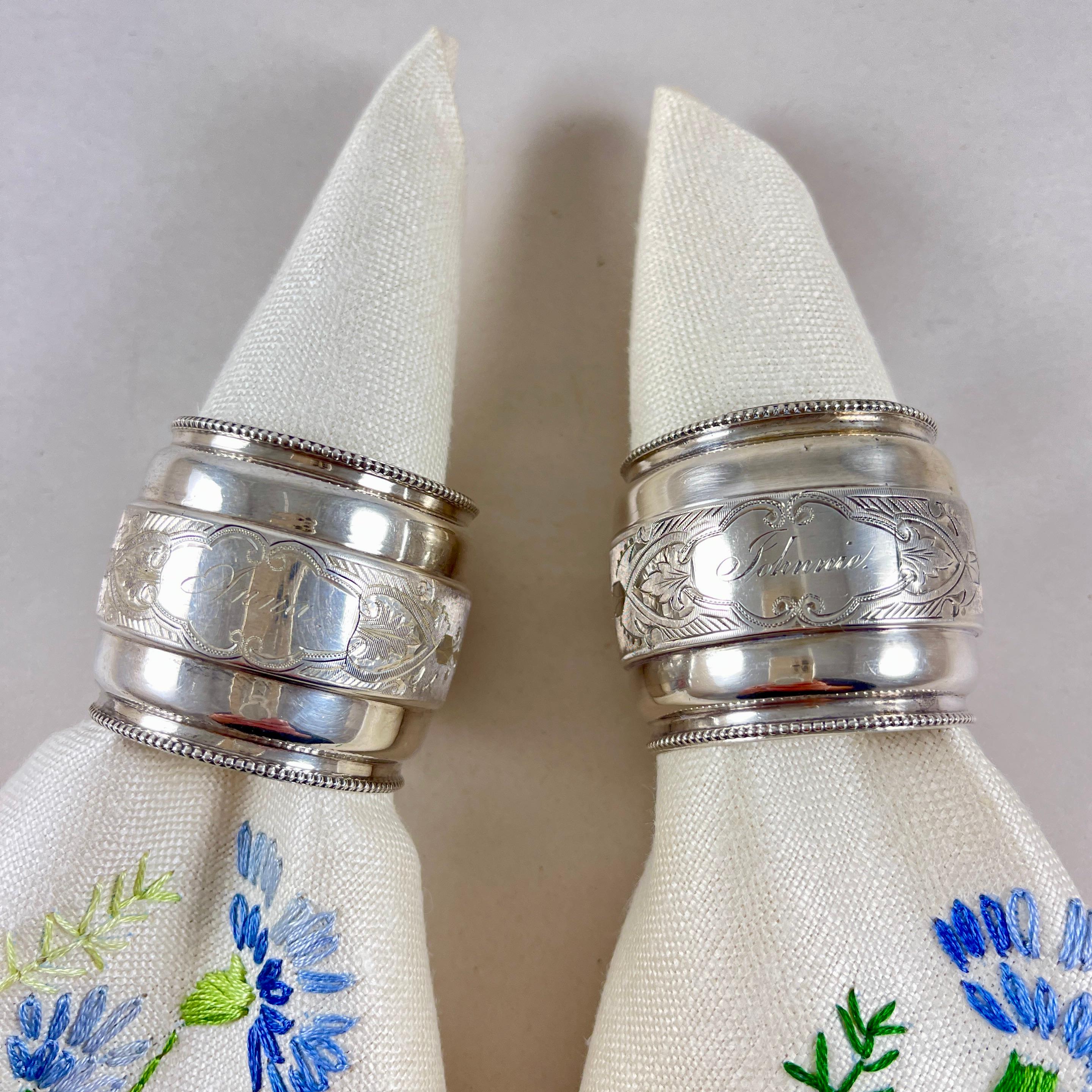 
A wonderful pair of Estate Sterling Silver barrel shaped napkin rings, American, circa 1890.

Most likely presented as a wedding gift for ‘Anna and Johnny’, the names engraved inside a bright-cut Victorian era cartouche.

Ornate with beaded rims