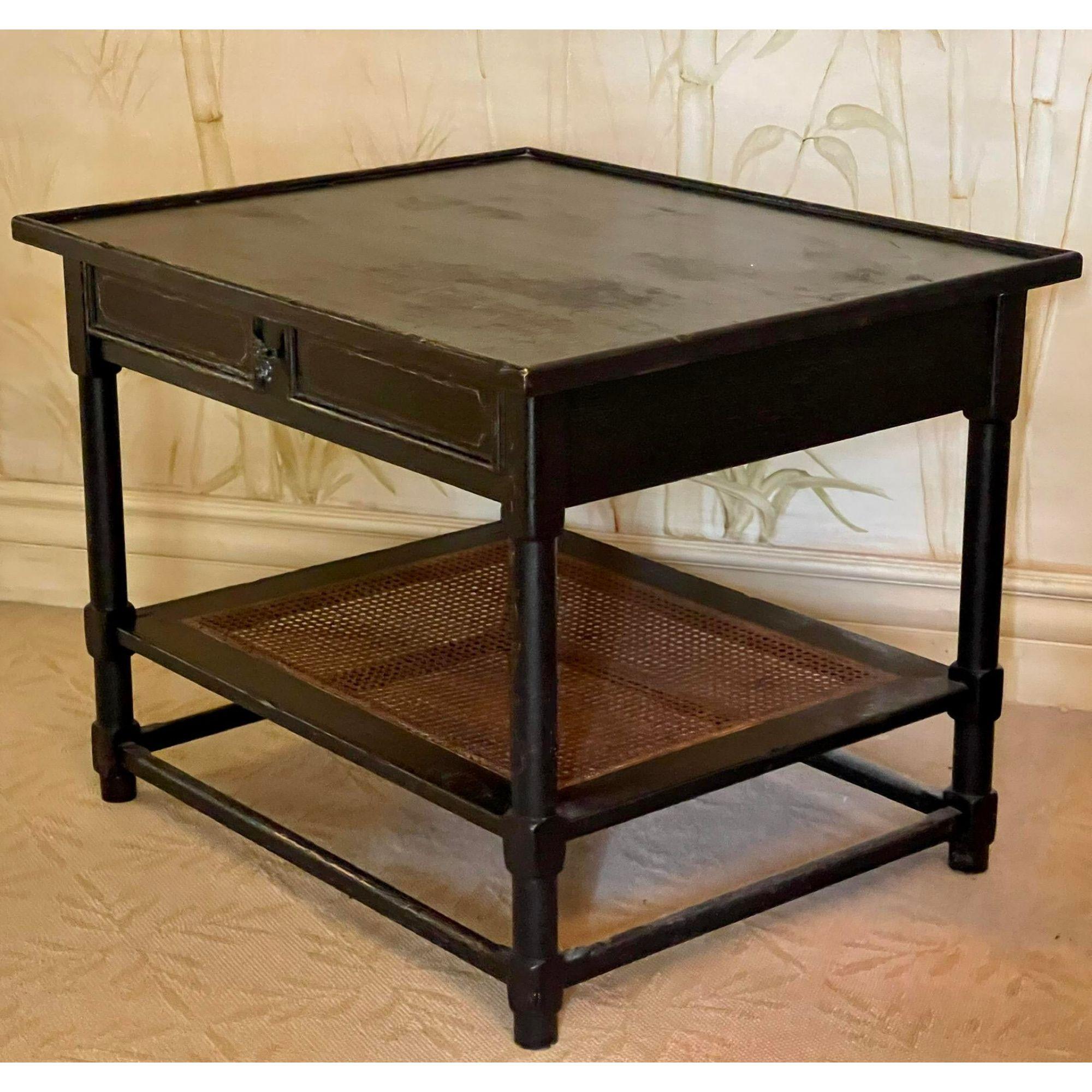 19th C style Charles Pollock black & gold chinoiserie side table. It features a rustic black painted finish with gilt details and a cane bottom shelf

Additional information: 
Materials: Gold
Color: Black
Brand: William Switzer
Designer: