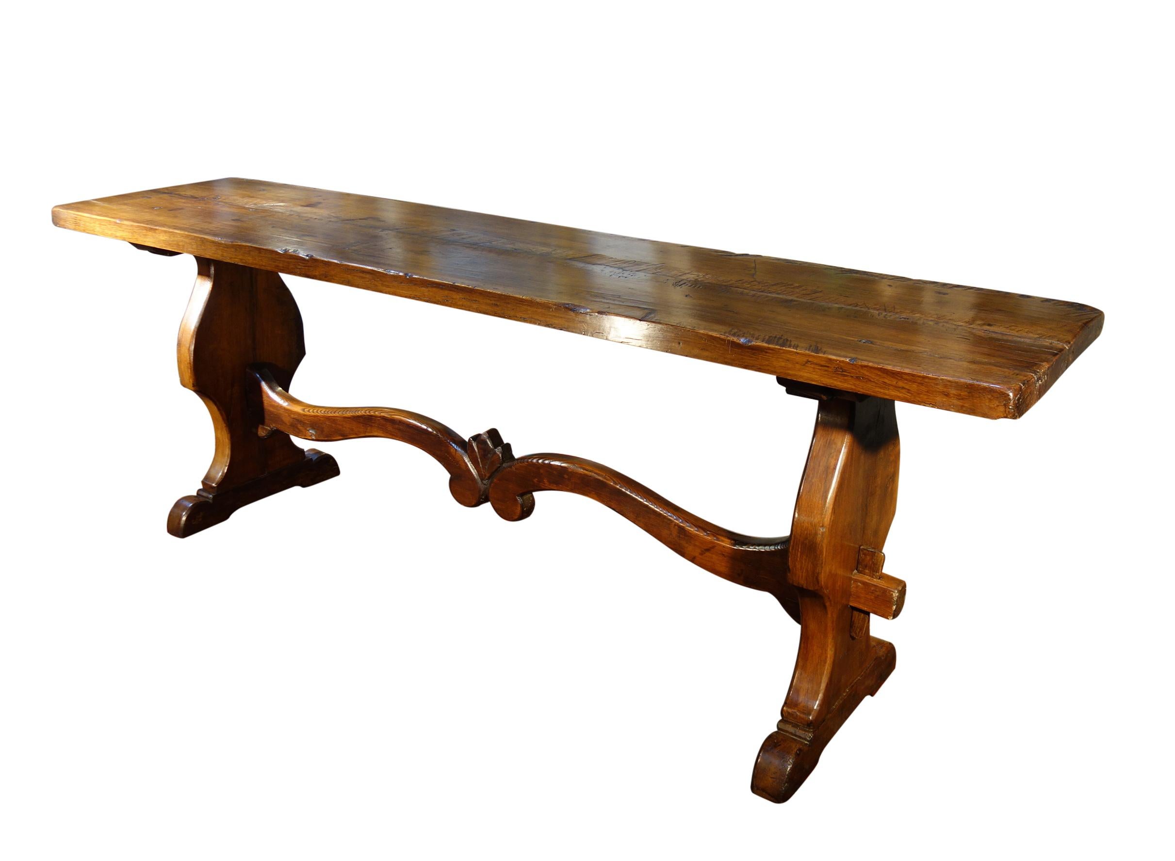 THIS ANTIQUE TABLE HAS SOLD, INQUIRE FOR A CUSTOM ORDER

COPPE - Tuscan Trestle Table, Old World Style for Modern Living. This majestic antique Italian trestle style table with solid Italian Walnut 2-slab top and carved chalice-shaped bases with