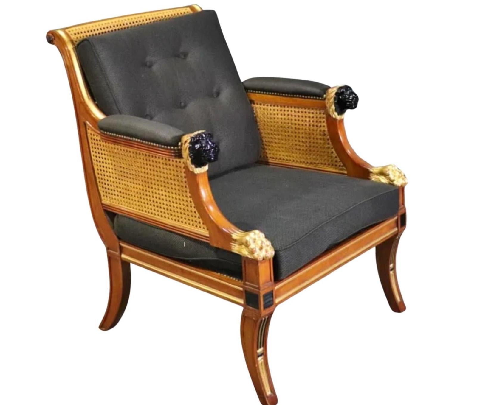 19th C Style Regency Mahogany Cane Back Giltwood Bergere Armchair. It is an exquisite example with Ebony lion hear arms and Giltwood paw details.