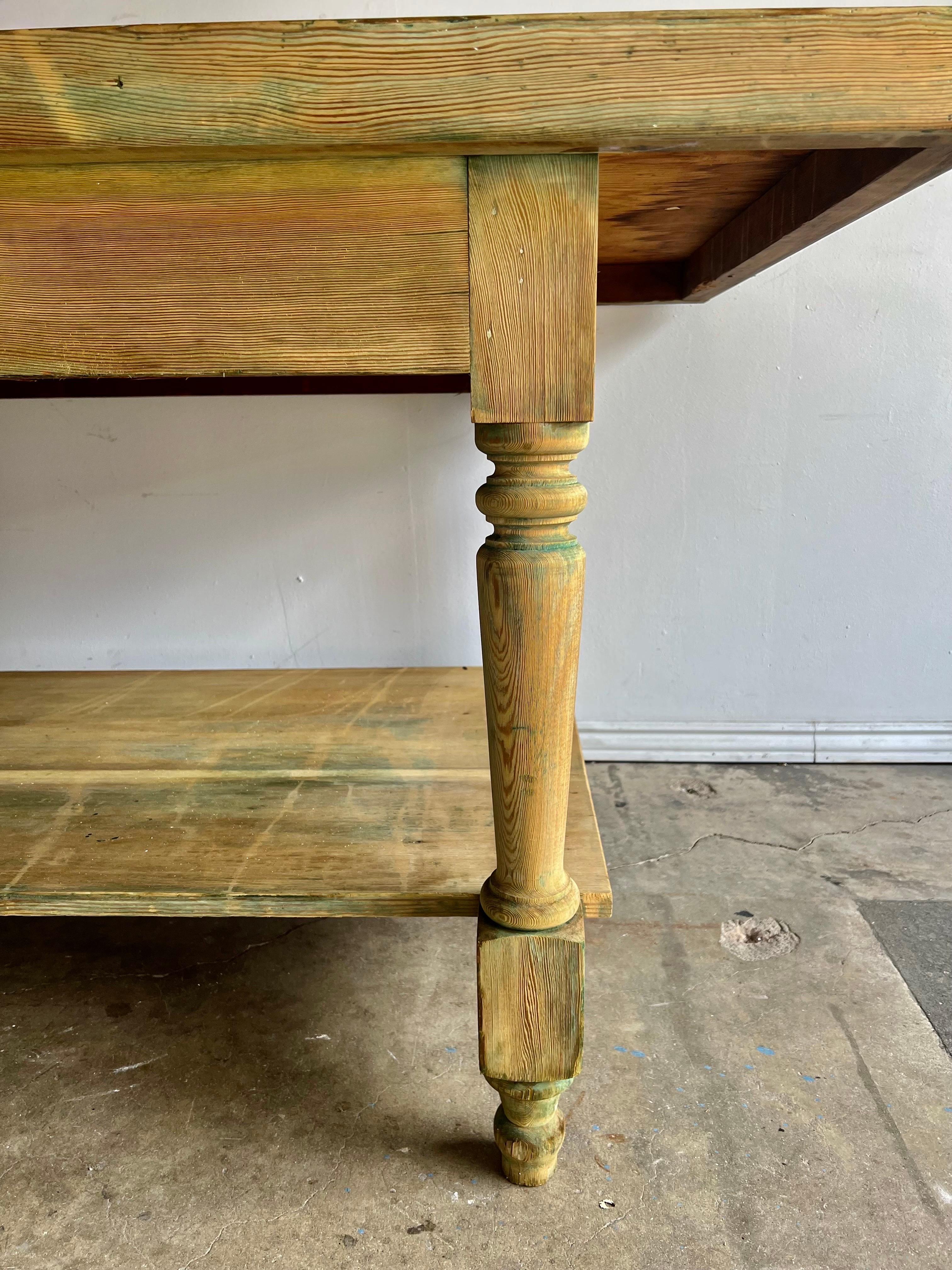 19th Century bleached wood Swedish rustic farm table. The table stands on four straight turned legs that connect the bottom shelf. Remnants of the original paint can be seen when observed closely.
