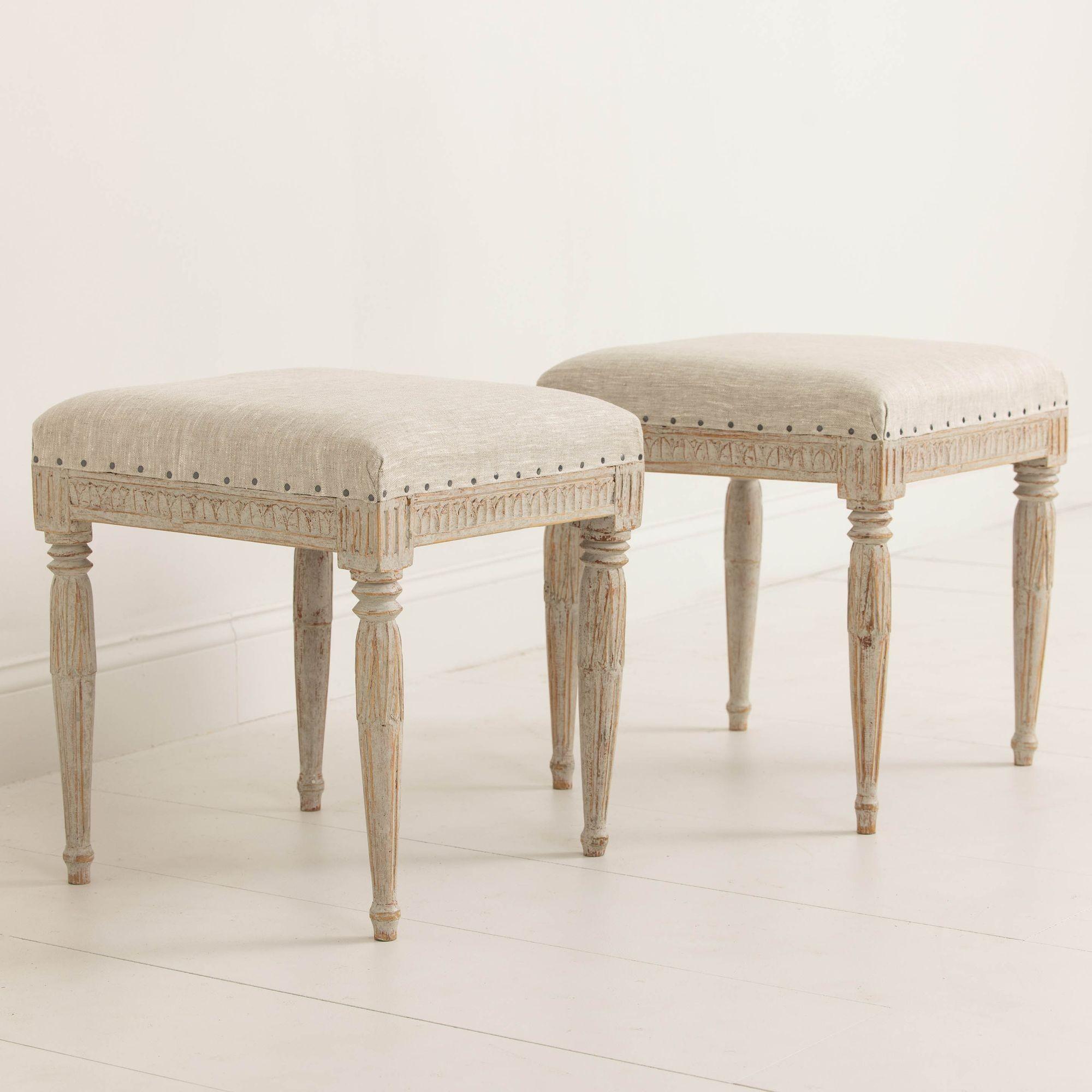 Beautifully carved pair of Swedish benches from the late Gustavian period, newly upholstered in linen with nailhead trim, circa 1830. Signed by Johannes Ericsson, 1803-1865, a chair maker in Knipered, a village in Lindome outside Göteborg. The
