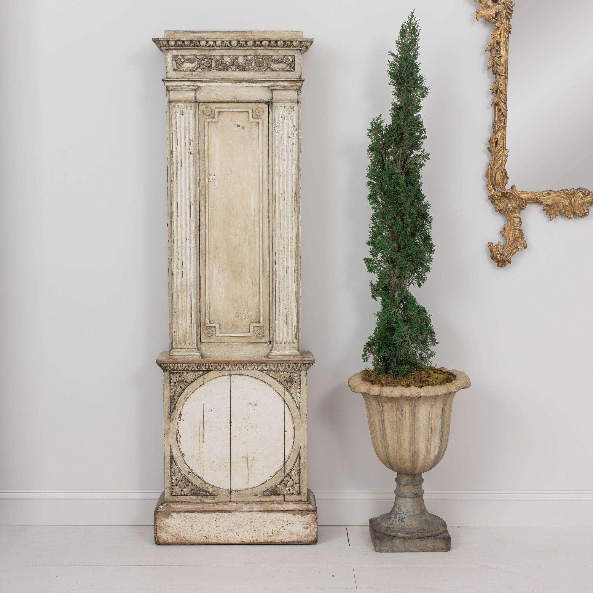 A 19th century Swedish pilaster cupboard from the Gustavian period in hand-scraped, original paint. This charming cupboard was formerly a tall case clock and has been fitted with shelves.