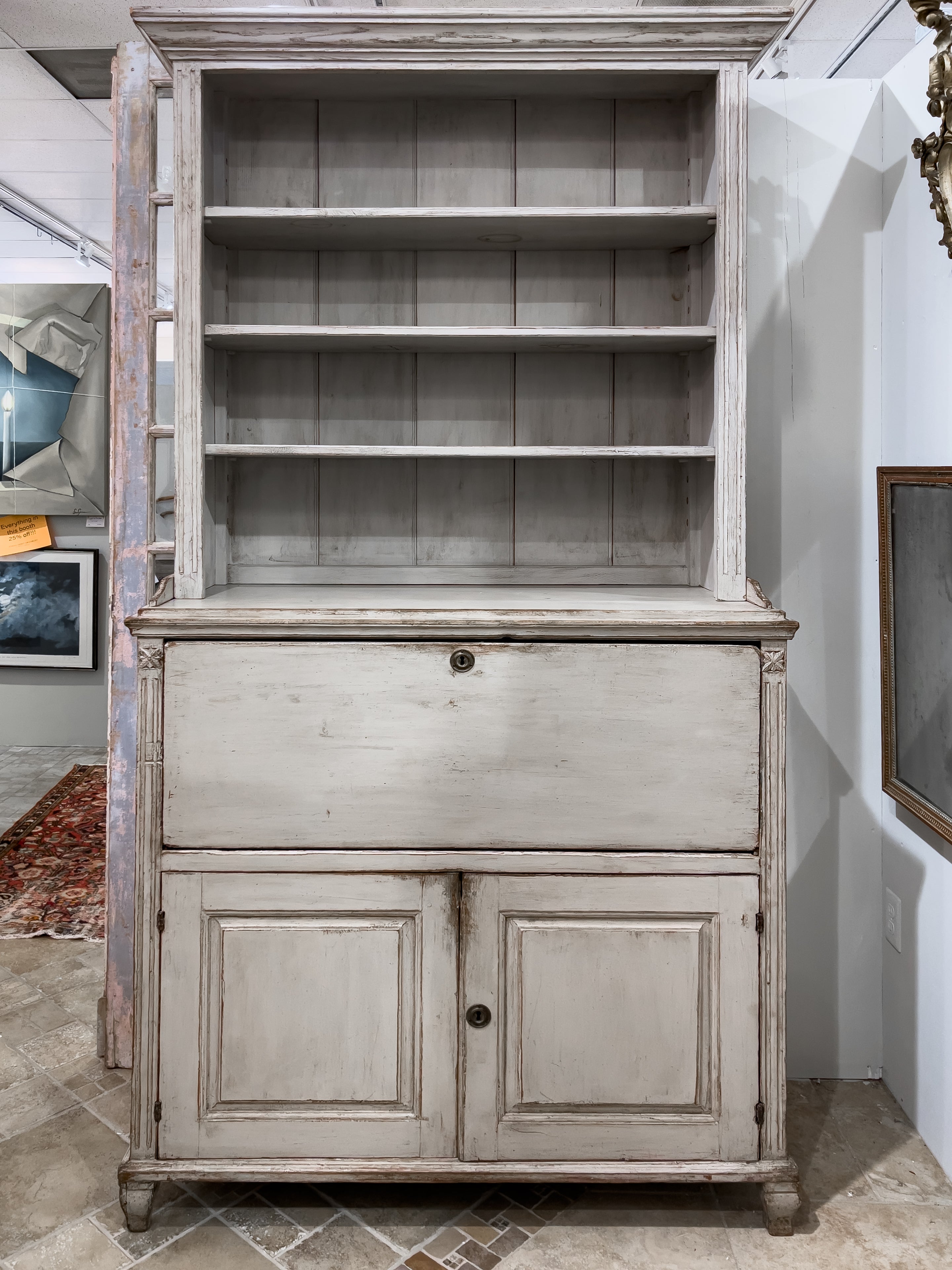 19th Century Swedish Secretary Desk with open book shelves above the fall front desk and bottom cabinet doors. The desk section has multiple small drawers and the lower section conceals 1 large pull out drawer and shelf above. It has a pale painted