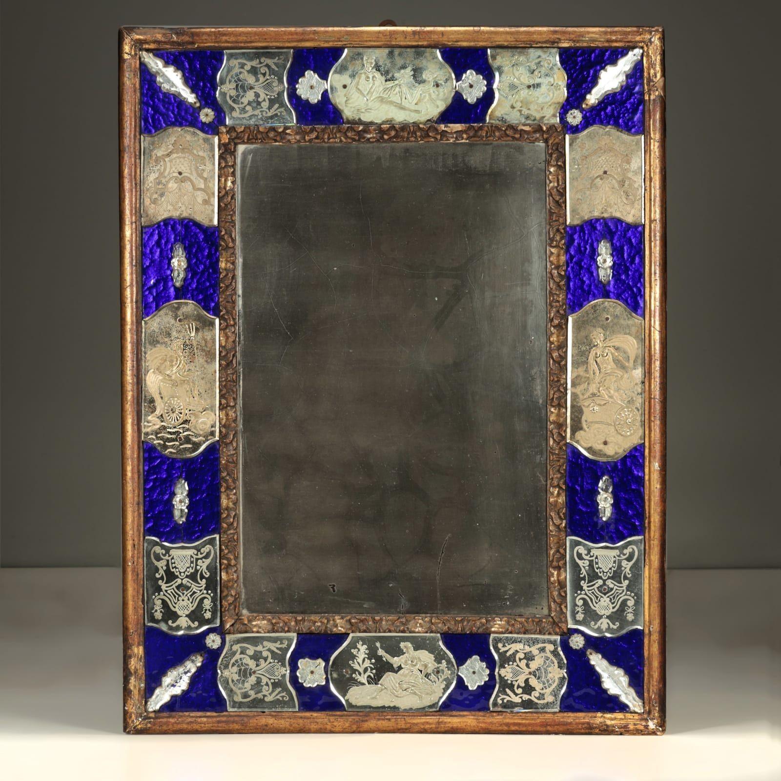 An unusual, Italian rectangular Murano sectional mirror in the Venetian taste with original cobalt blue glass and decorative, reverse etched mirror plates featuring mythological scenes. Border framed in carved original giltwood, circa 1800 or